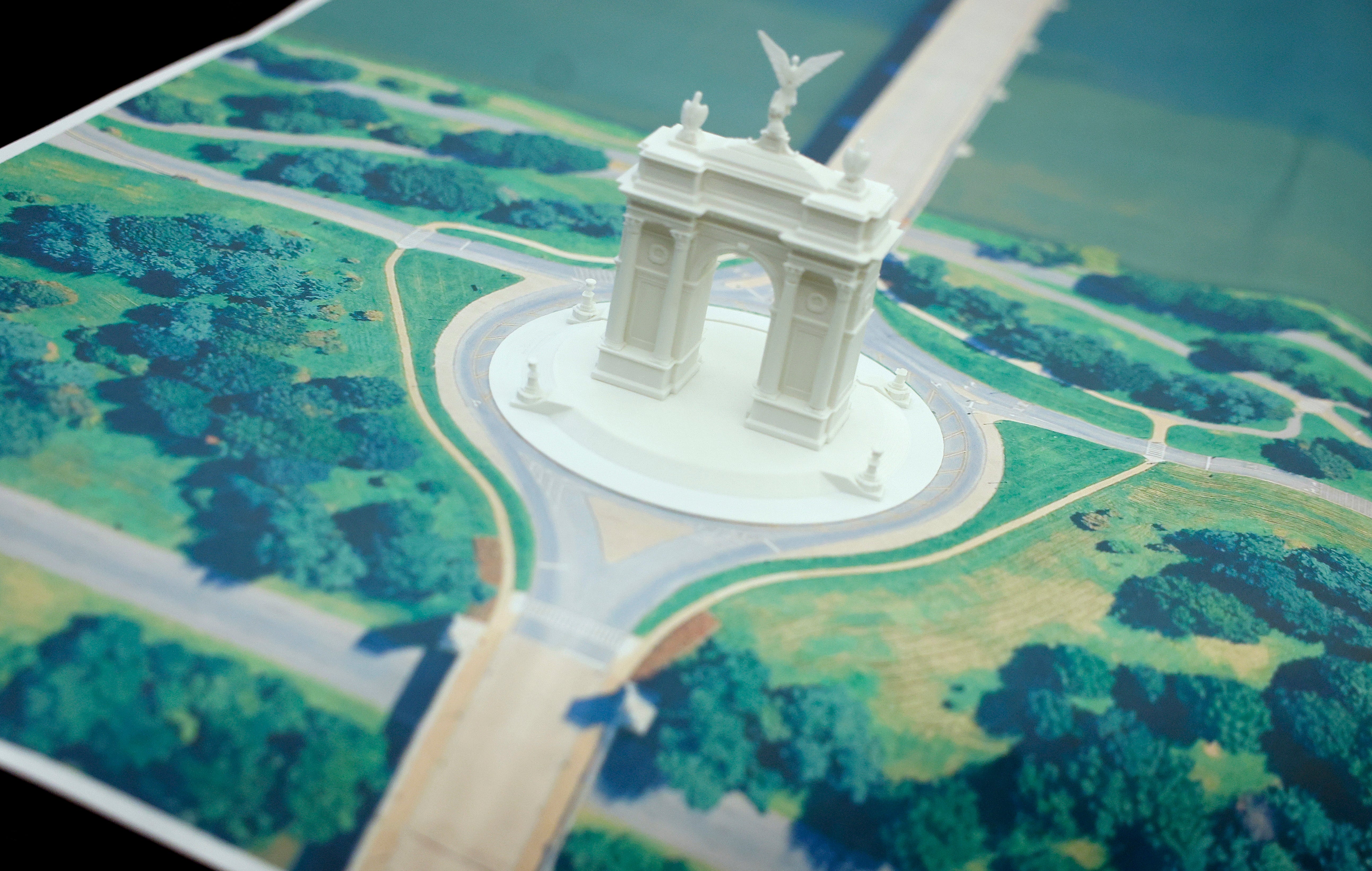 Scale exemplary of a neoclassical arch with pathways and greenery surrounding it