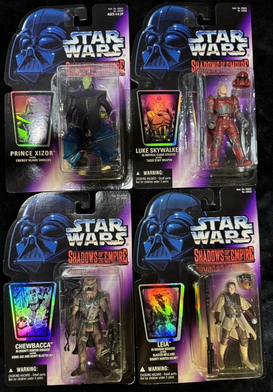 Four Star Wars action figures in packaging: Prince Xizor, Luke Skywalker, Chewbacca, and Leia from the Shadows of the Empire series