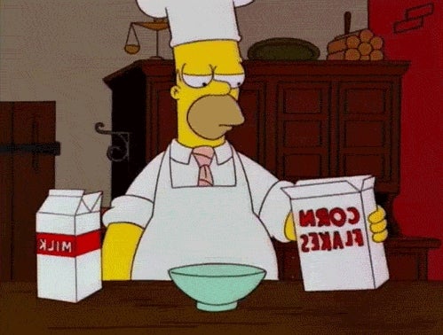 Cartoon character in a chef outfit prepares cereal with milk in a kitchen