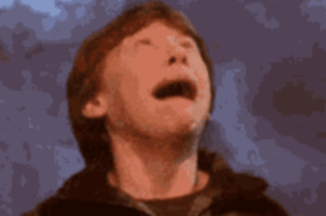 A person looking upwards with an open mouth, appearing surprised or excited