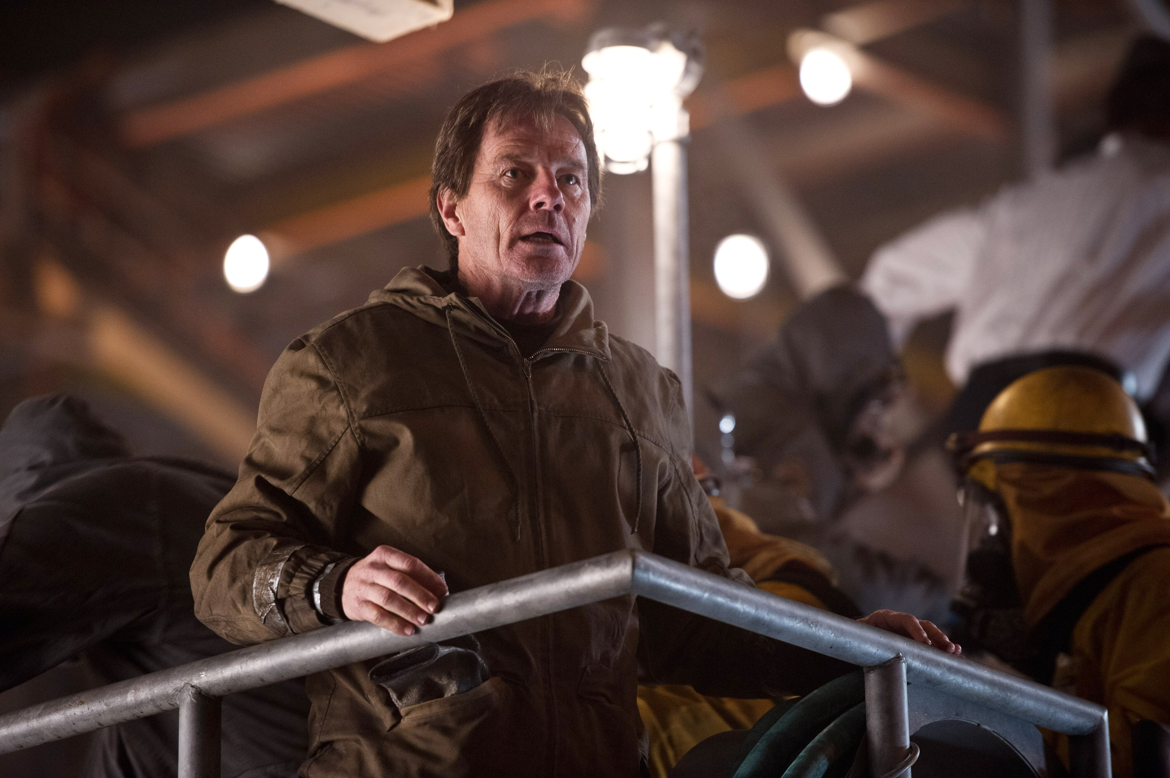 A idiosyncratic   successful  a protective suit   stands connected  a metallic  level    among others successful  akin  gear, suggesting an aggravated  oregon  hazardous environment