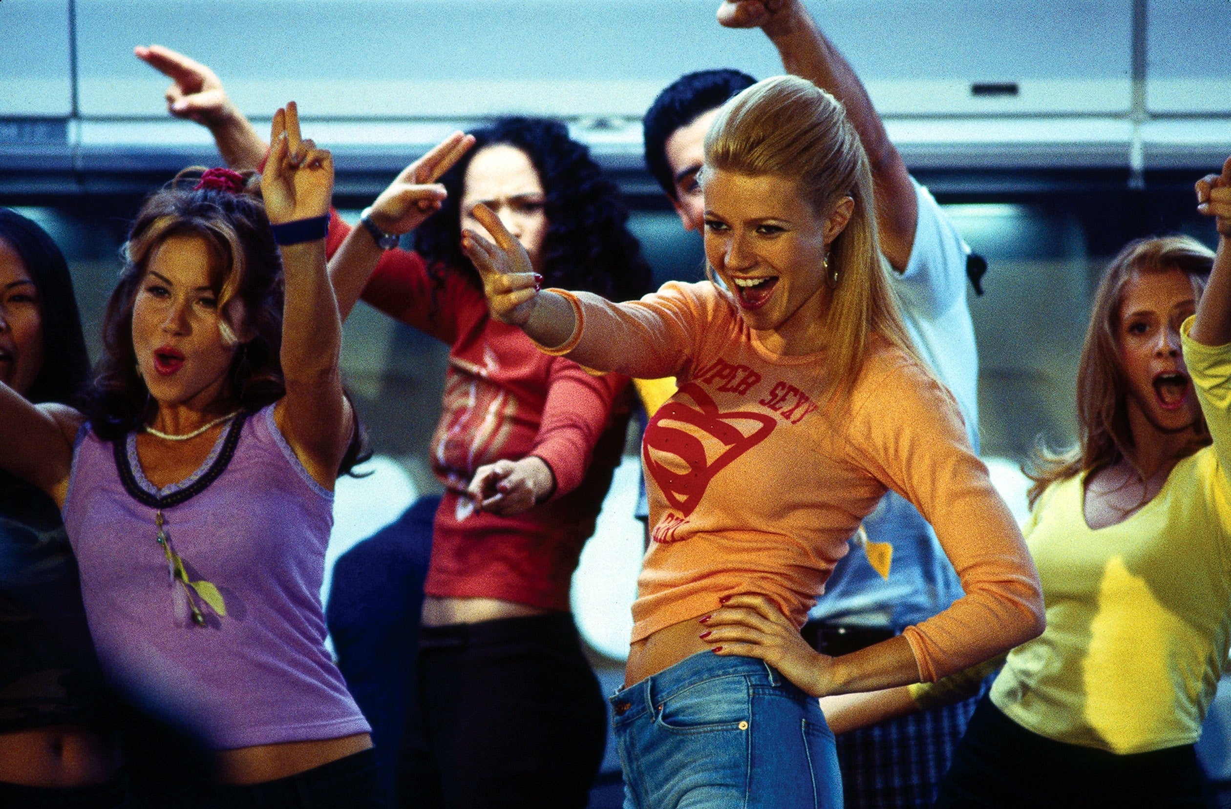 Group of radical   dancing energetically, 1  wearing a apical  with a "Superman" logo