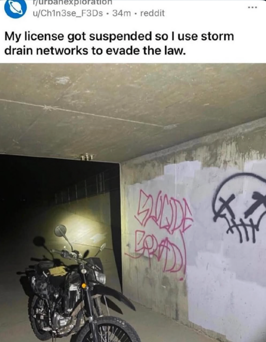 A motorcycle is parked in a storm drain tunnel with graffiti on the walls, accompanied by a caption about evading law enforcement