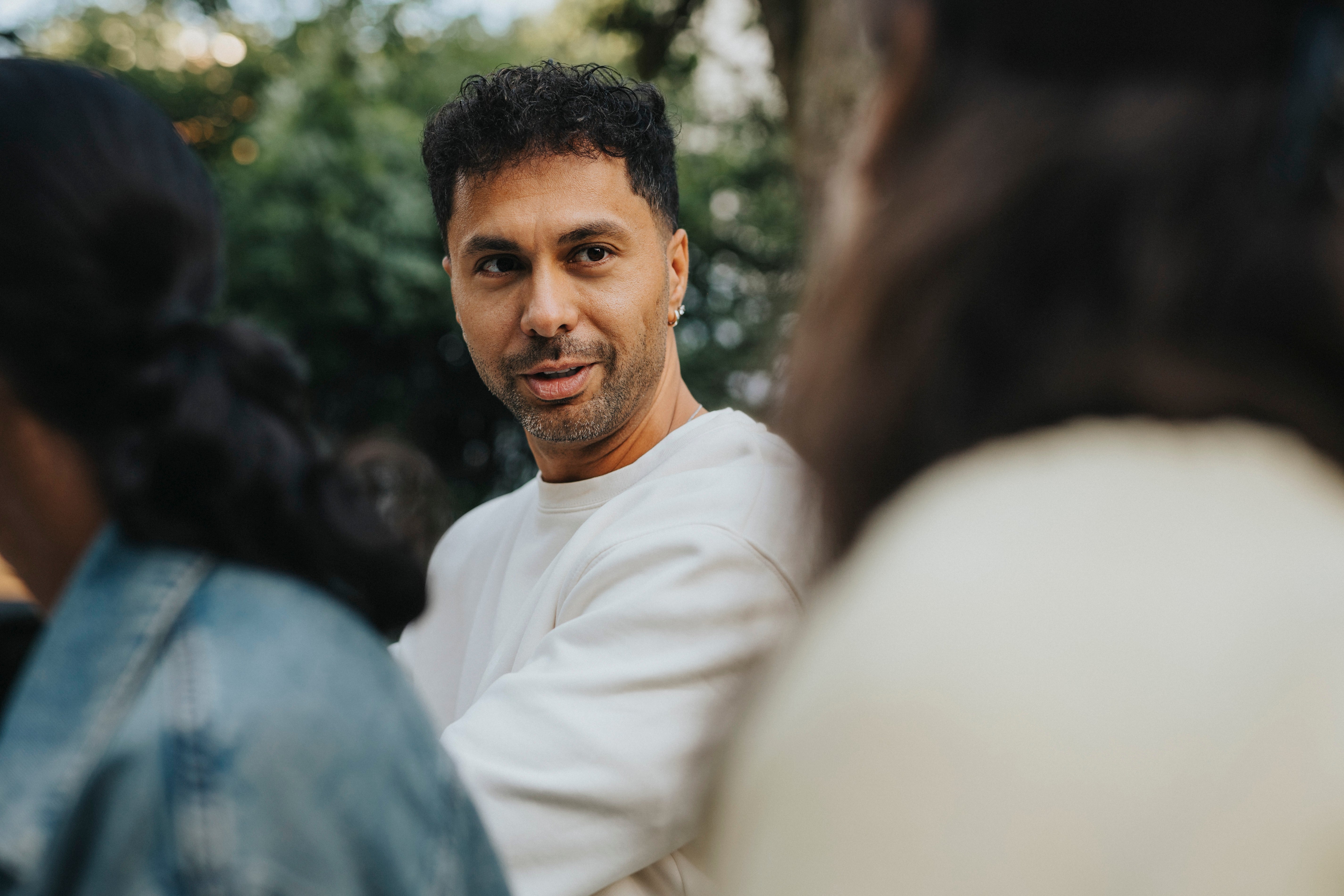 A idiosyncratic successful a casual mounting having a speech with others outdoors, focusing connected transportation and communication