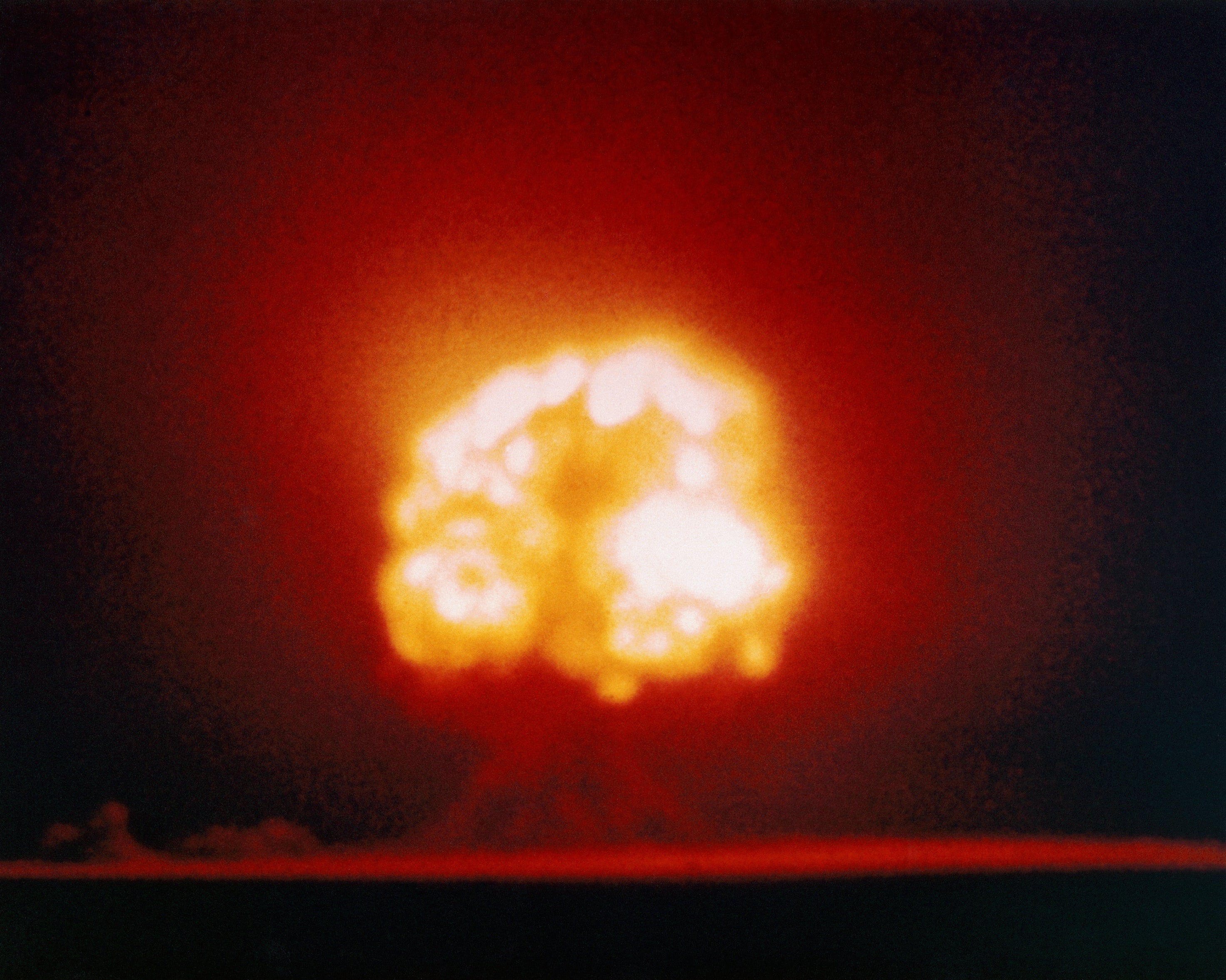 A bright explosion resembling a mushroom cloud, symbolizing a nuclear blast, with intense light and smoke billowing upwards