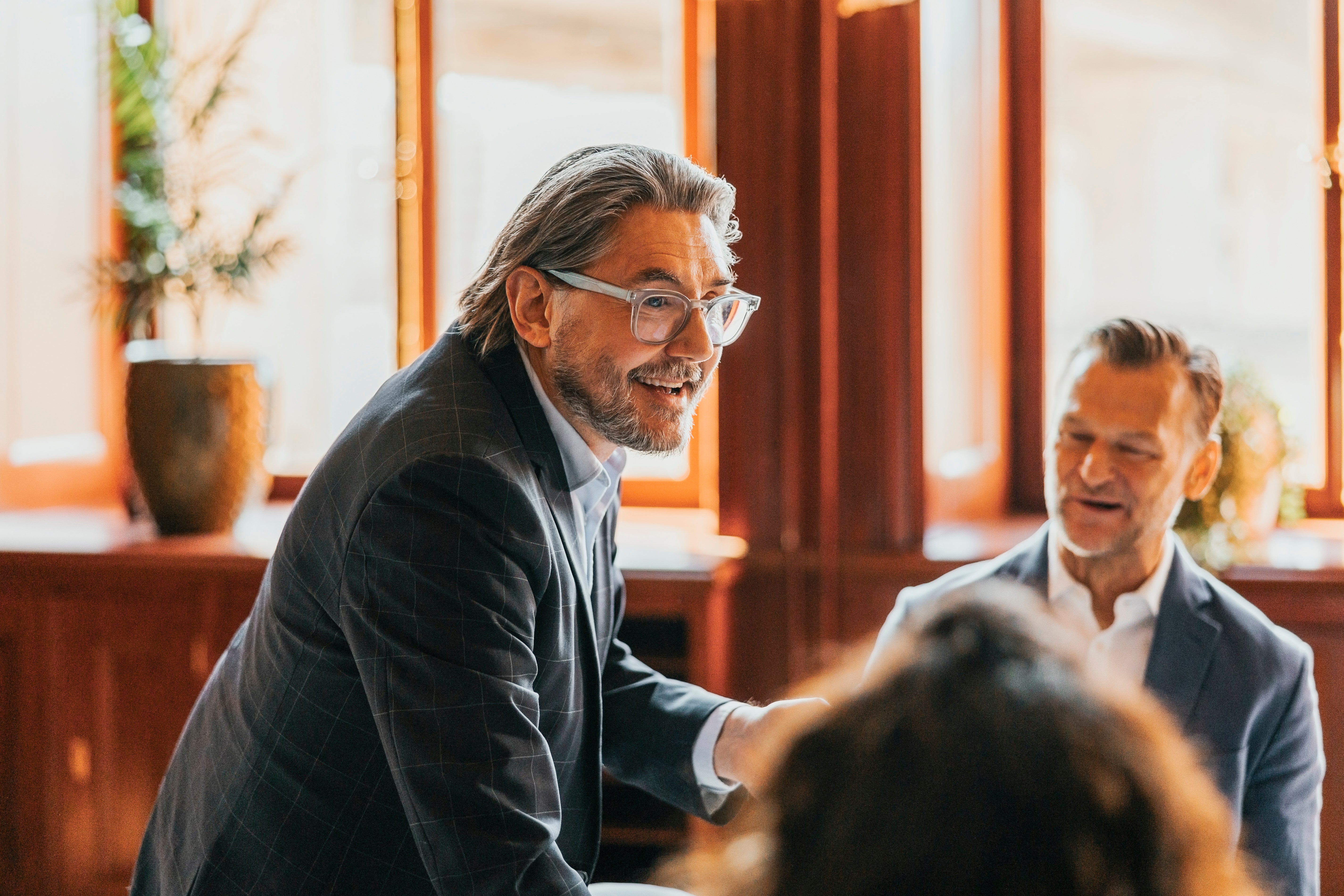 Man successful a suit speaks to a radical indoors, smiling warmly, suggesting a affirmative treatment oregon lecture