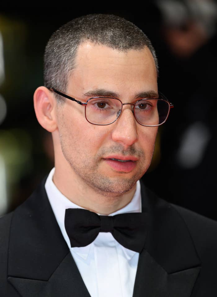 Jack Antonoff on a red carpet wearing a formal tuxedo with a bow tie and glasses