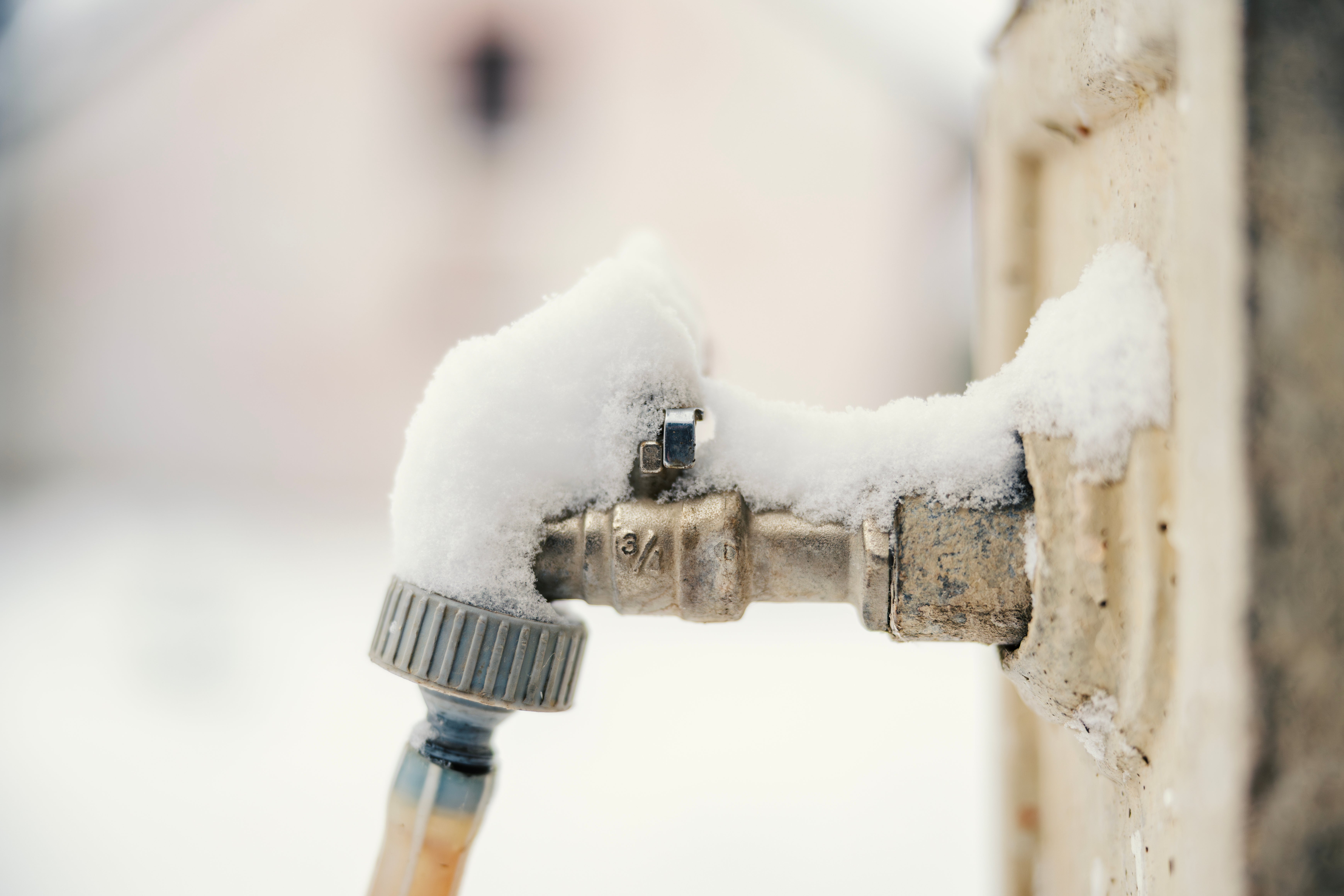 Outdoor faucet covered in snow