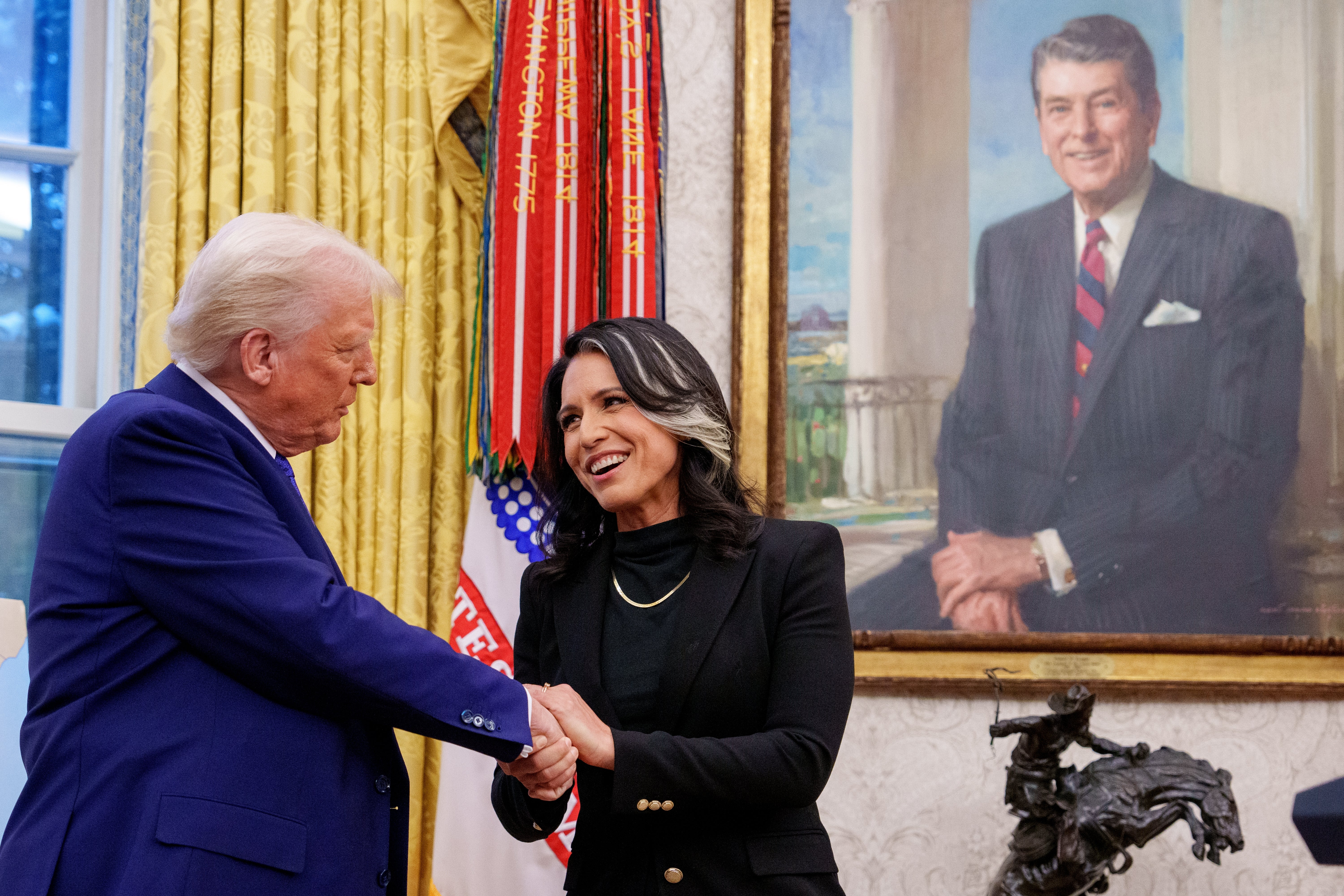 ewly sworn in Director of National Intelligence Tulsi Gabbard shakes hands with U.S. President Donald Trump in the Oval Office