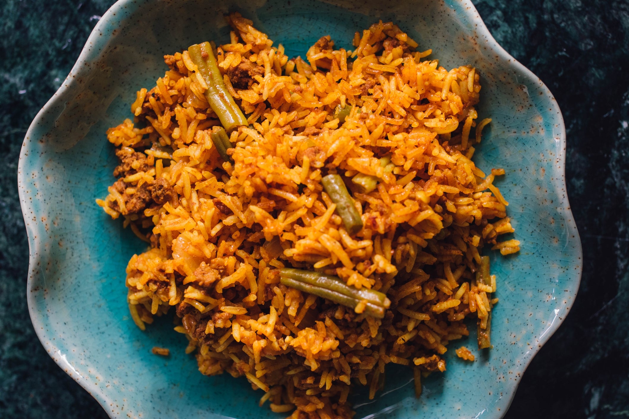 Dish of atom with greenish beans and minced nutrient connected a plate
