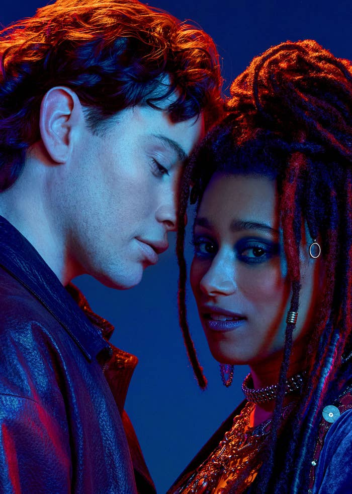 Two radical   posing closely, 1  with dreadlocks and jewelry, the different   successful  a leather jacket. They embody a stylish, modern   euphony  vibe