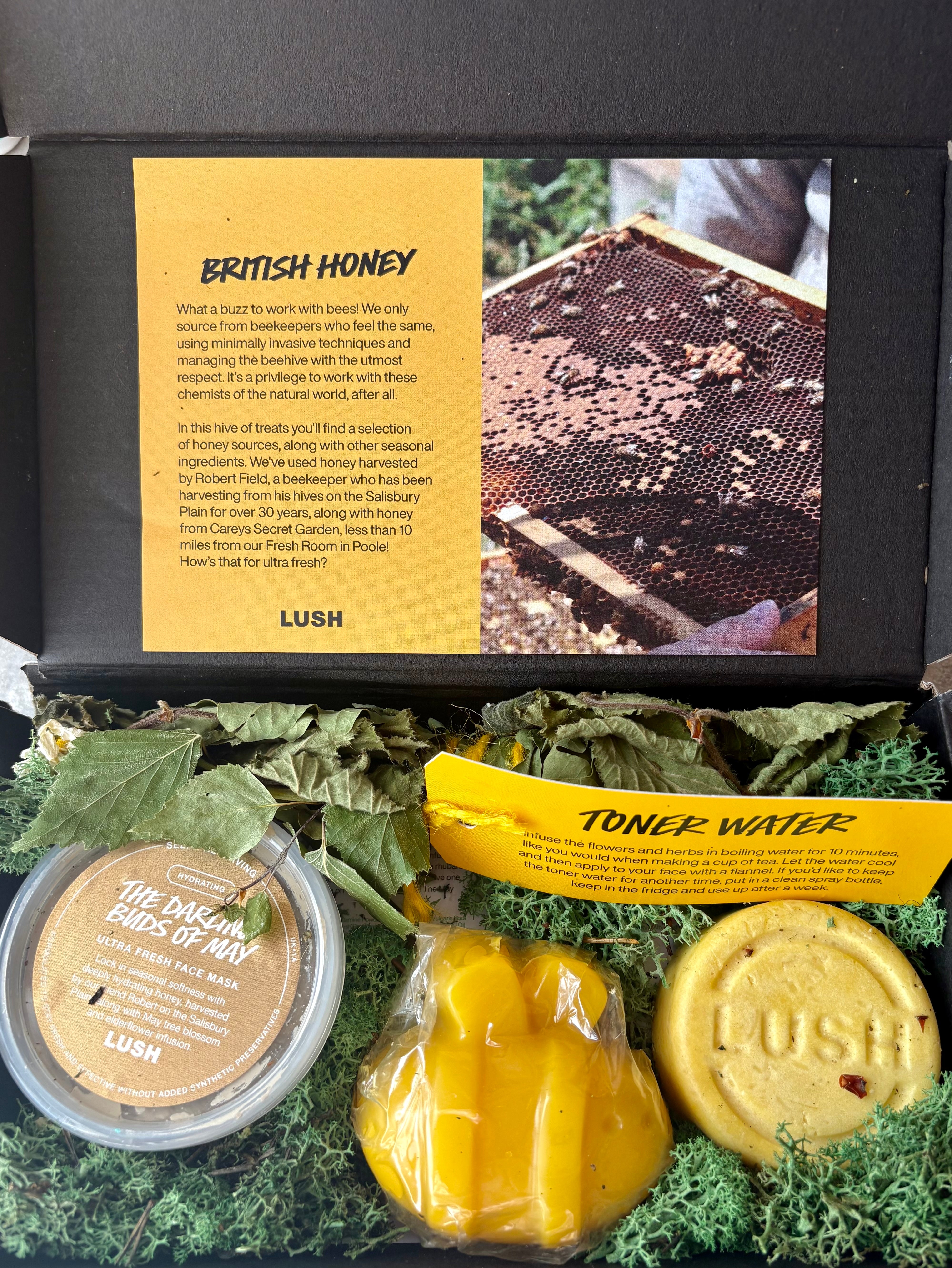 Lush gift set featuring British Honey skincare items, including a face mask and toner water, presented with a nature-inspired design