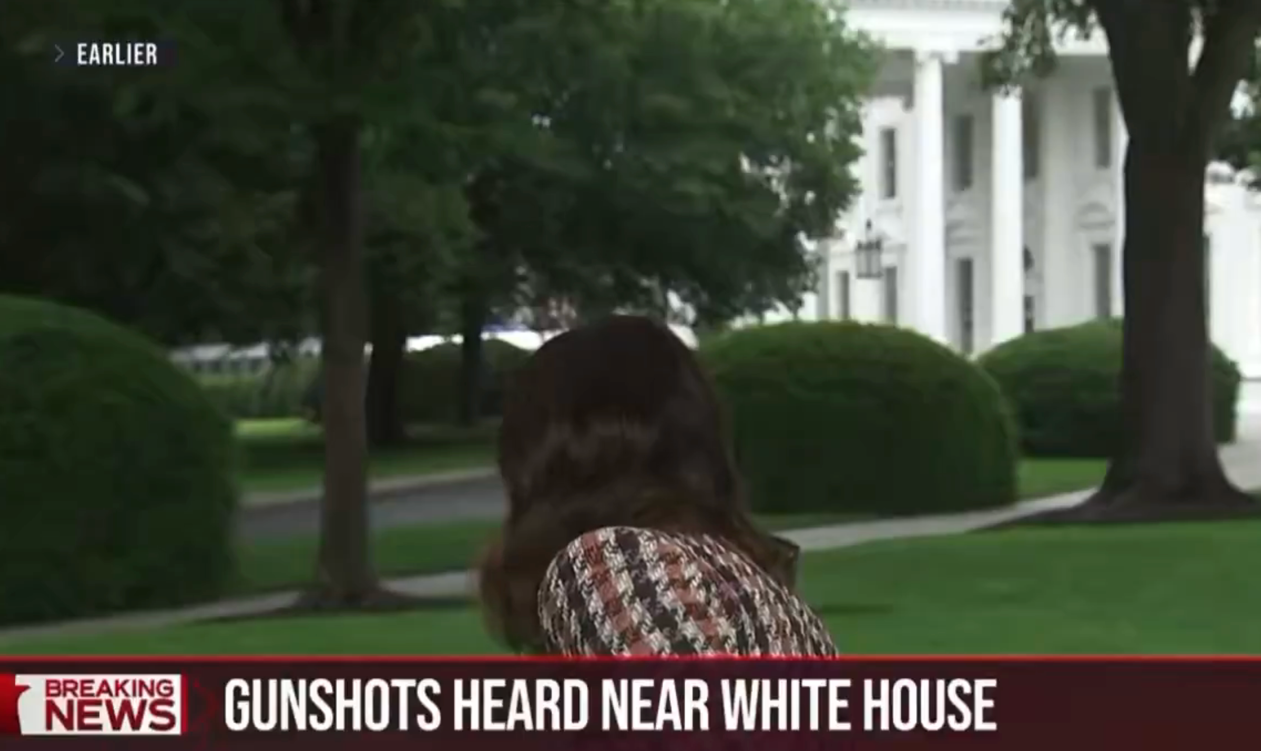 A reporter stands near the White House with a headline: "Gunshots Heard Near White House."