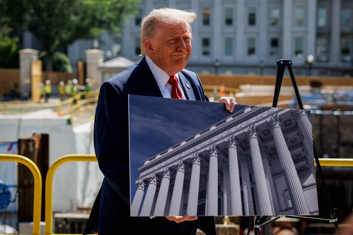 US President Donald Trump speaks to members of the media near the ballroom construction site at the White House