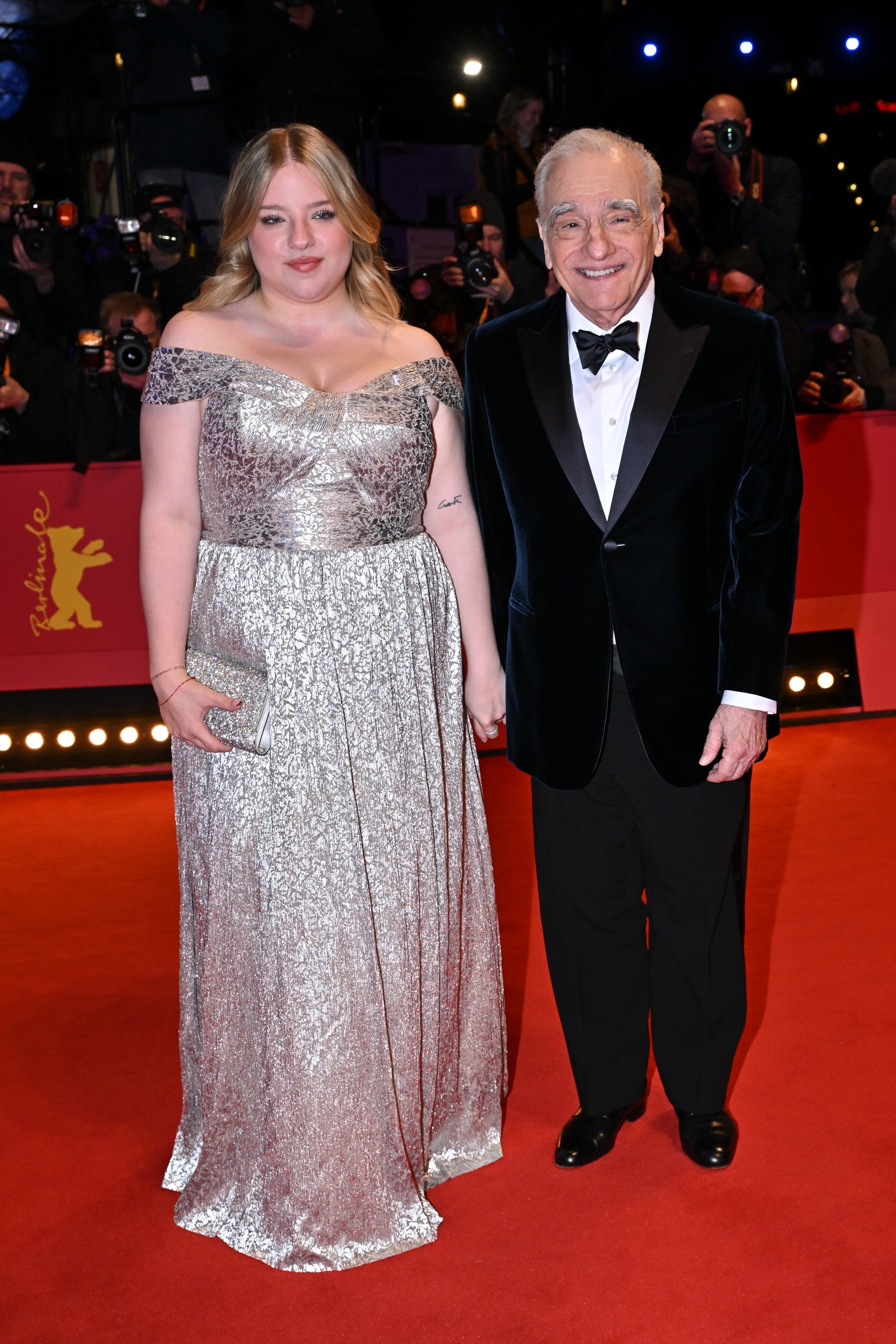 Francesca Scorsese and Martin Scorsese holding hands connected  the reddish  carpet