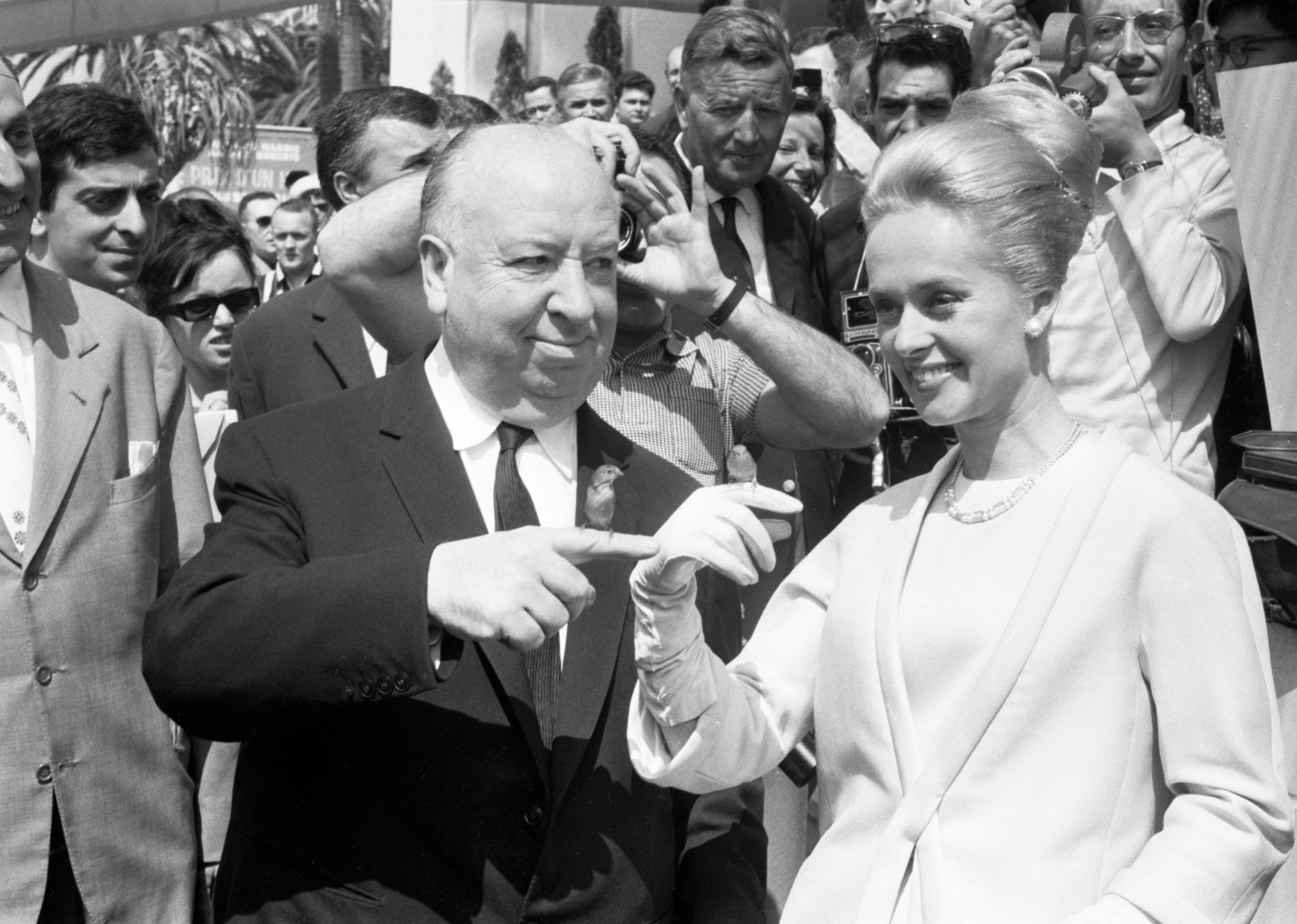 I don't cognize  who these radical   are. A antheral   and pistillate   interact playfully successful  beforehand   of a crowd, with the pistillate   extending her gloved hand