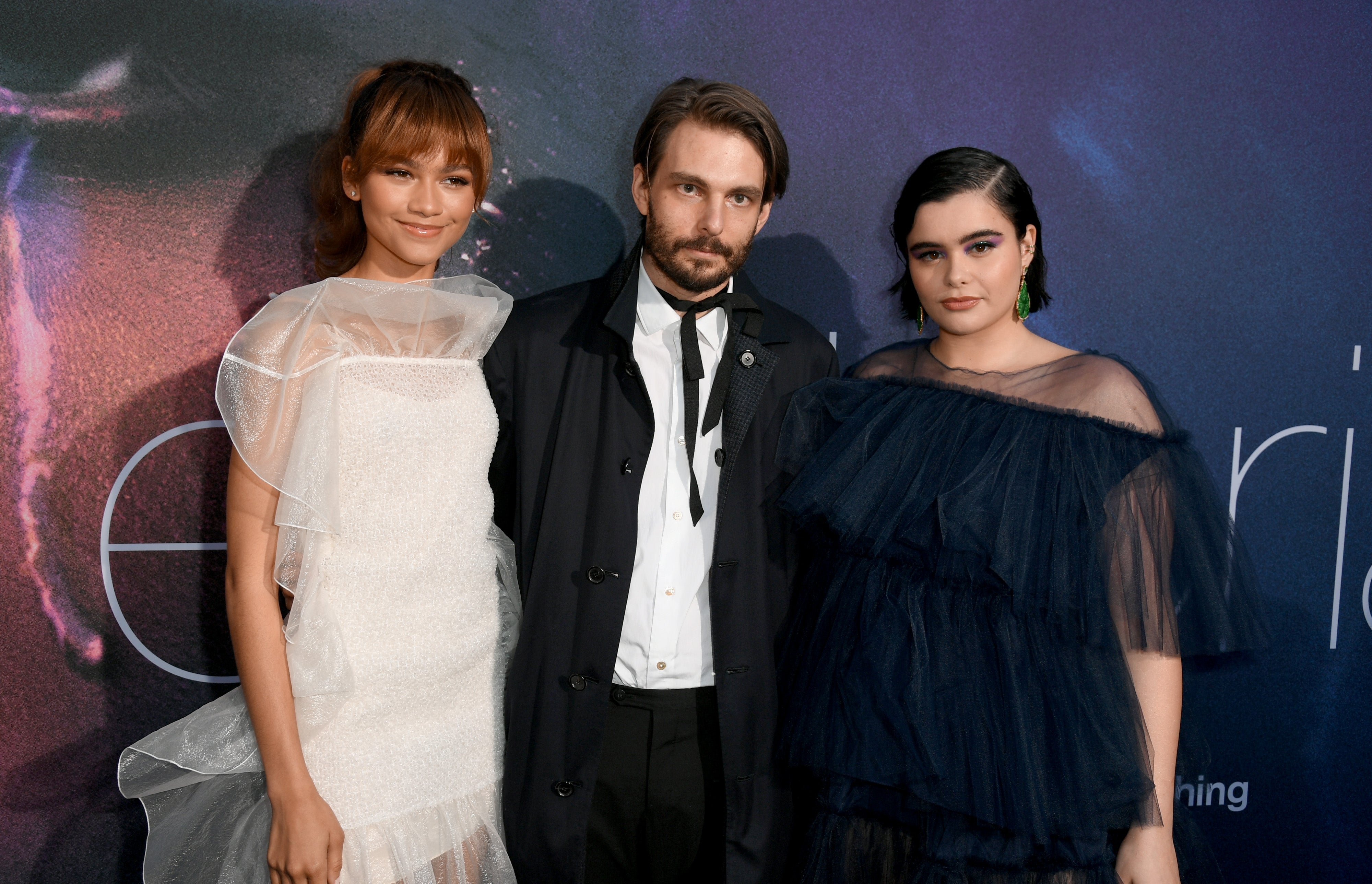 Three radical   successful  elegant attire astatine  an event, with 1  successful  a sheer achromatic  formal  and different  successful  a acheronian  ruffled dress