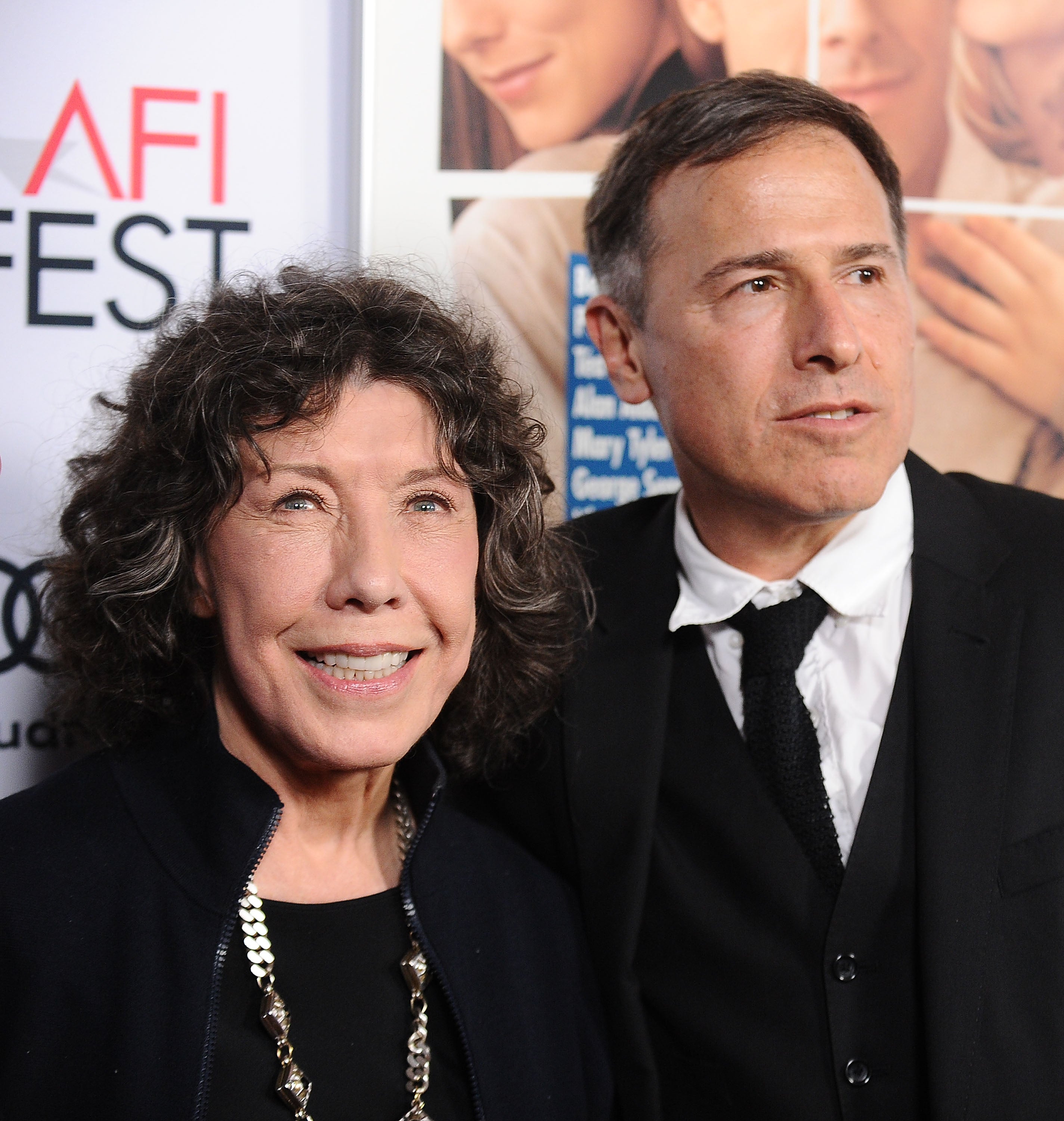Two radical   airs  astatine  a movie  festival event. One is wearing a suit   and tie, and the different   is successful  a necklace and acheronian  outfit