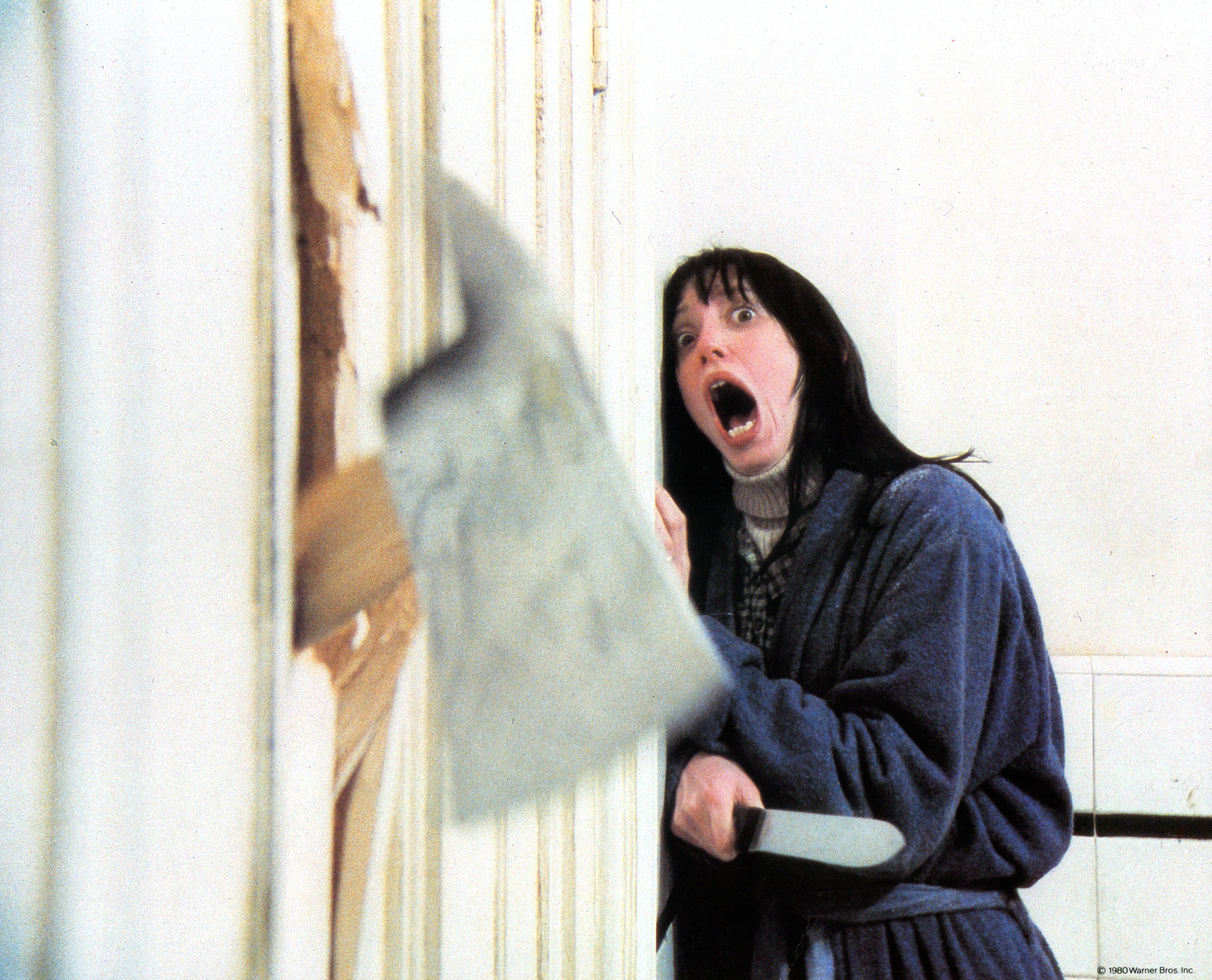 Person successful  a bathrobe holding a knife, screaming arsenic  an axe breaks done  the door
