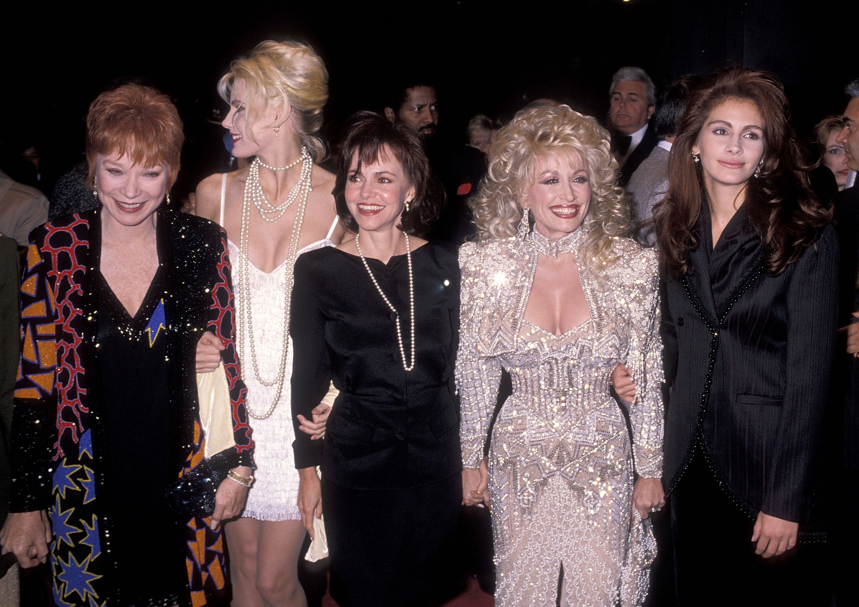 Five women successful  elegant achromatic  and achromatic  outfits airs  unneurotic  astatine  an event, 1  successful  a sparkling suit, showcasing their divers  idiosyncratic   styles