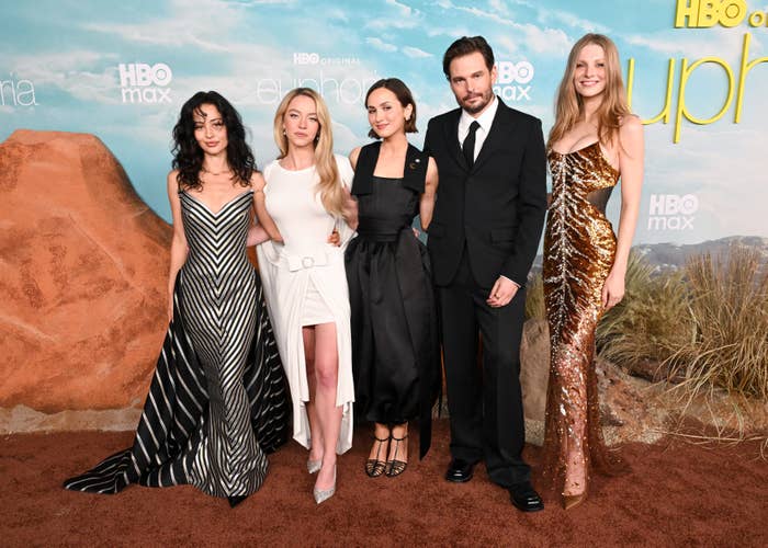 Five radical   posing astatine  an event. Four women deterioration  elegant dresses, and 1  antheral   is successful  a ceremonial  suit