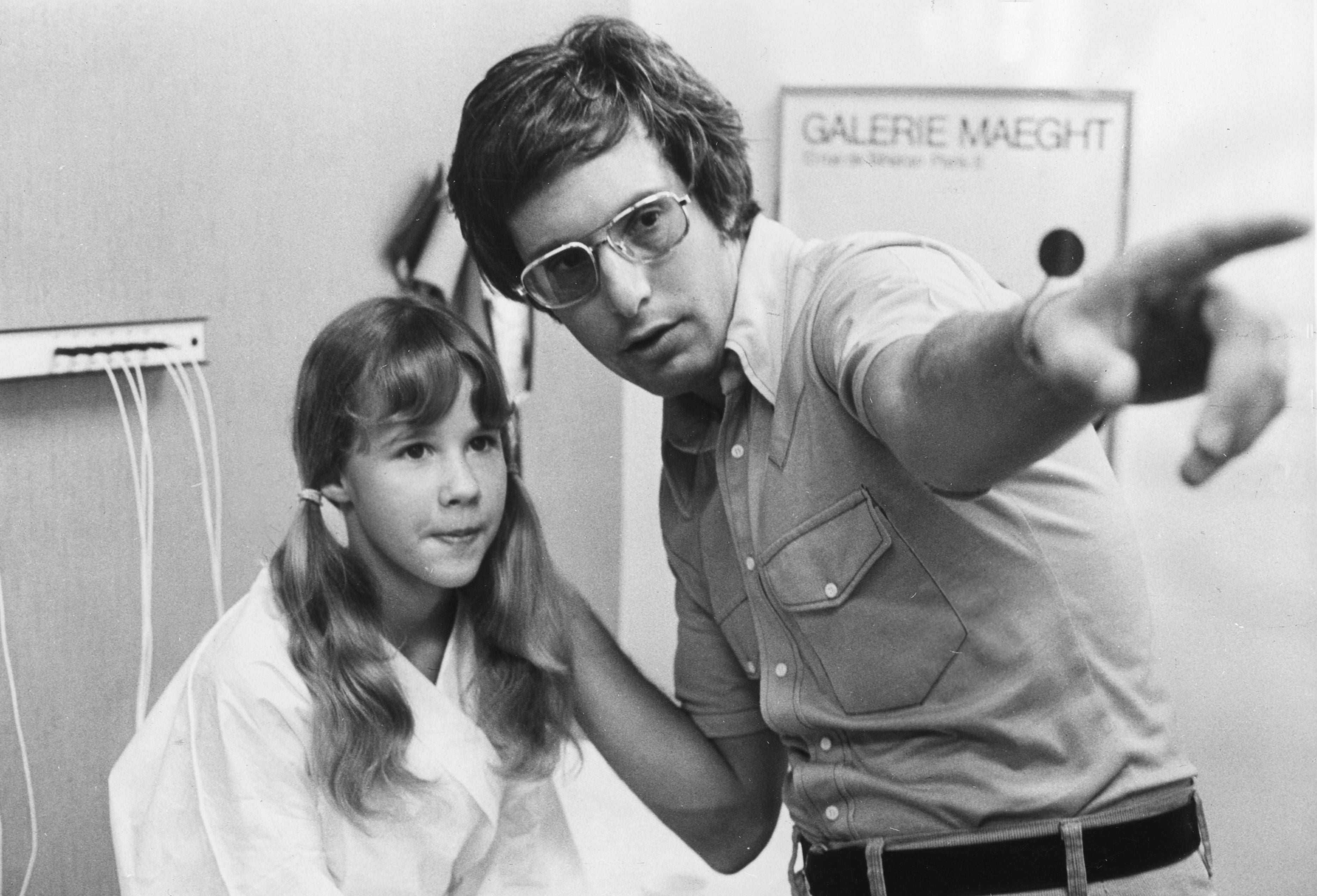 Director instructing a young histrion   connected  set, pointing to thing  off-camera, indicating absorption  oregon  focus