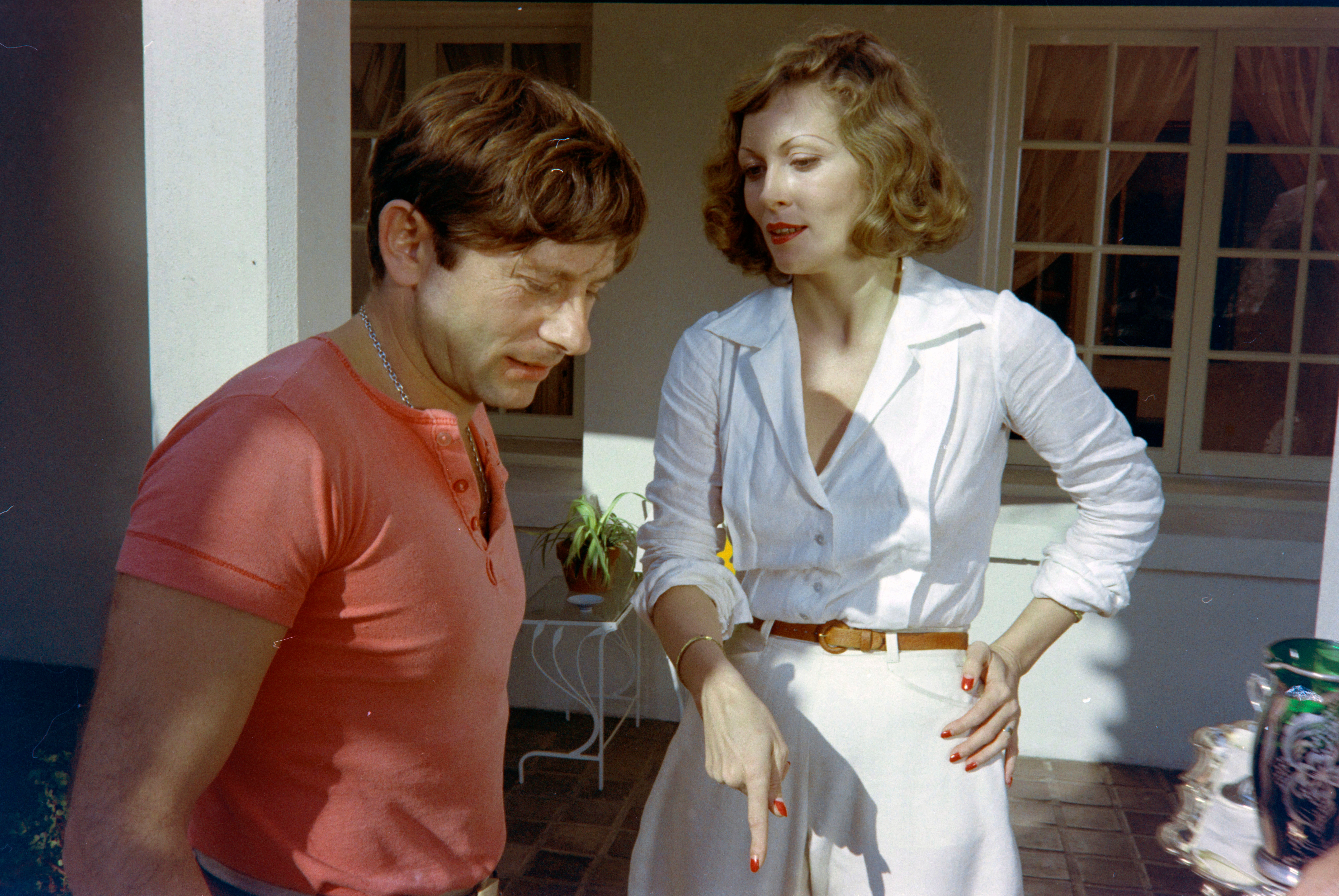 Two radical   lasting  unneurotic  extracurricular  a house, 1  wearing a casual t-shirt, the different   successful  a achromatic  blouse and skirt, engaged successful  conversation