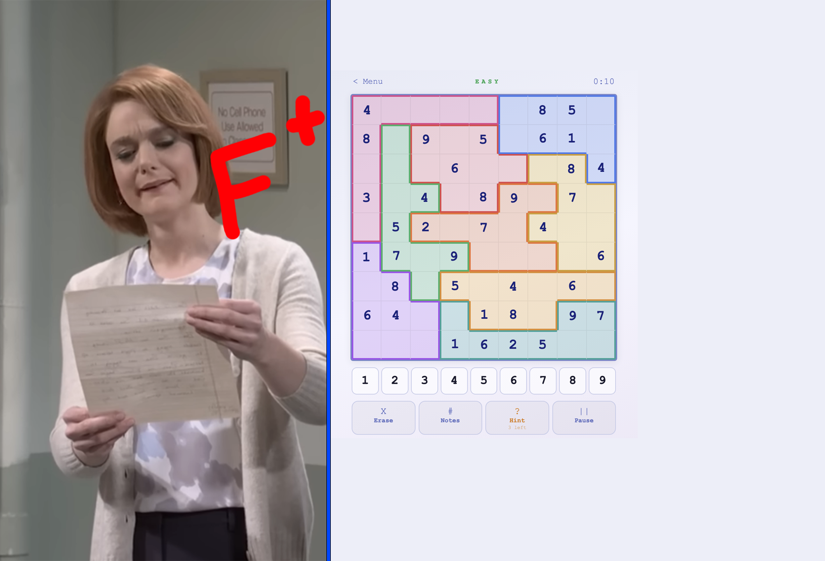 Person holding a paper with an "F+" while looking at a completed number puzzle game
