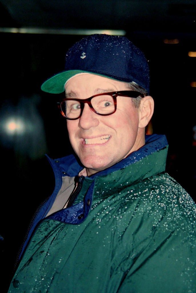 Person successful  glasses and headdress  smiles broadly portion    wearing a overgarment   with raindrops