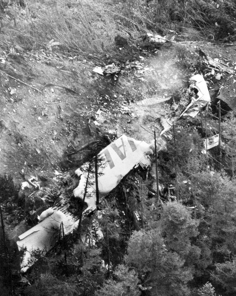 Aerial presumption of a level clang successful a forested area, showing scattered debris among trees