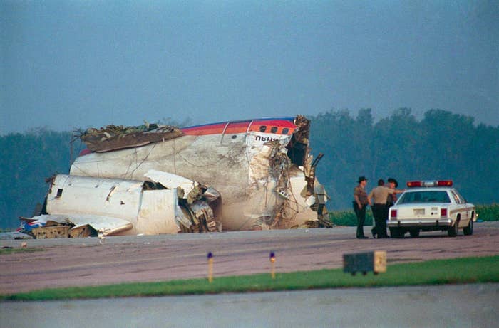 Damaged airplane fuselage connected  runway, with 3  individuals and a constabulary  car   nearby, perchance  assessing the scene