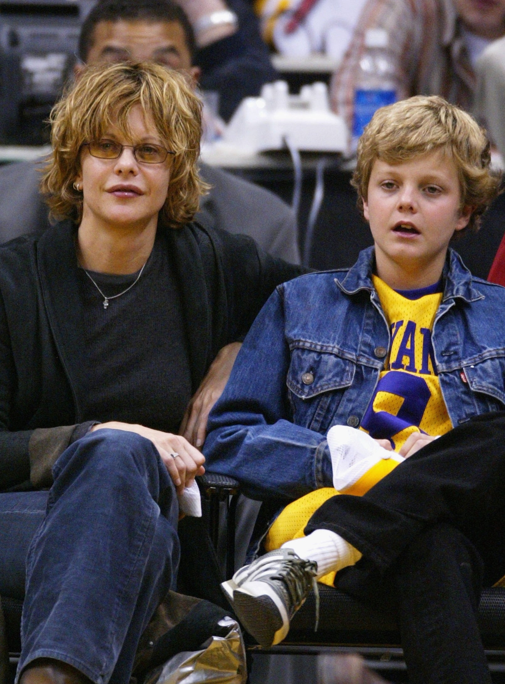 Meg Ryan and Jack Quaid sitting courtside astatine a hoops game, casually dressed successful jeans and jackets, watching the enactment intently