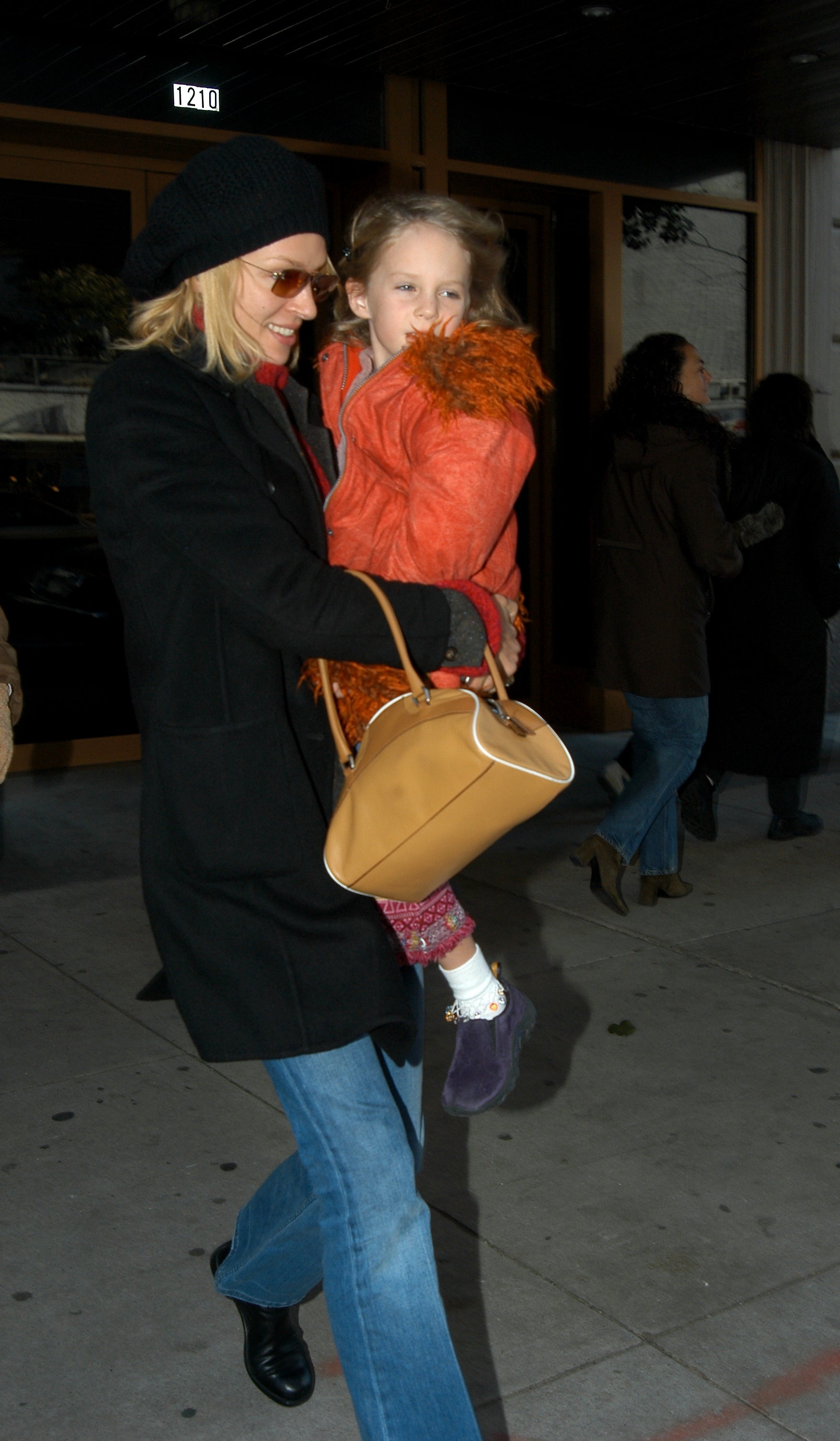 Uma Thurman carries her daughter, Maya, from a screening of a movie