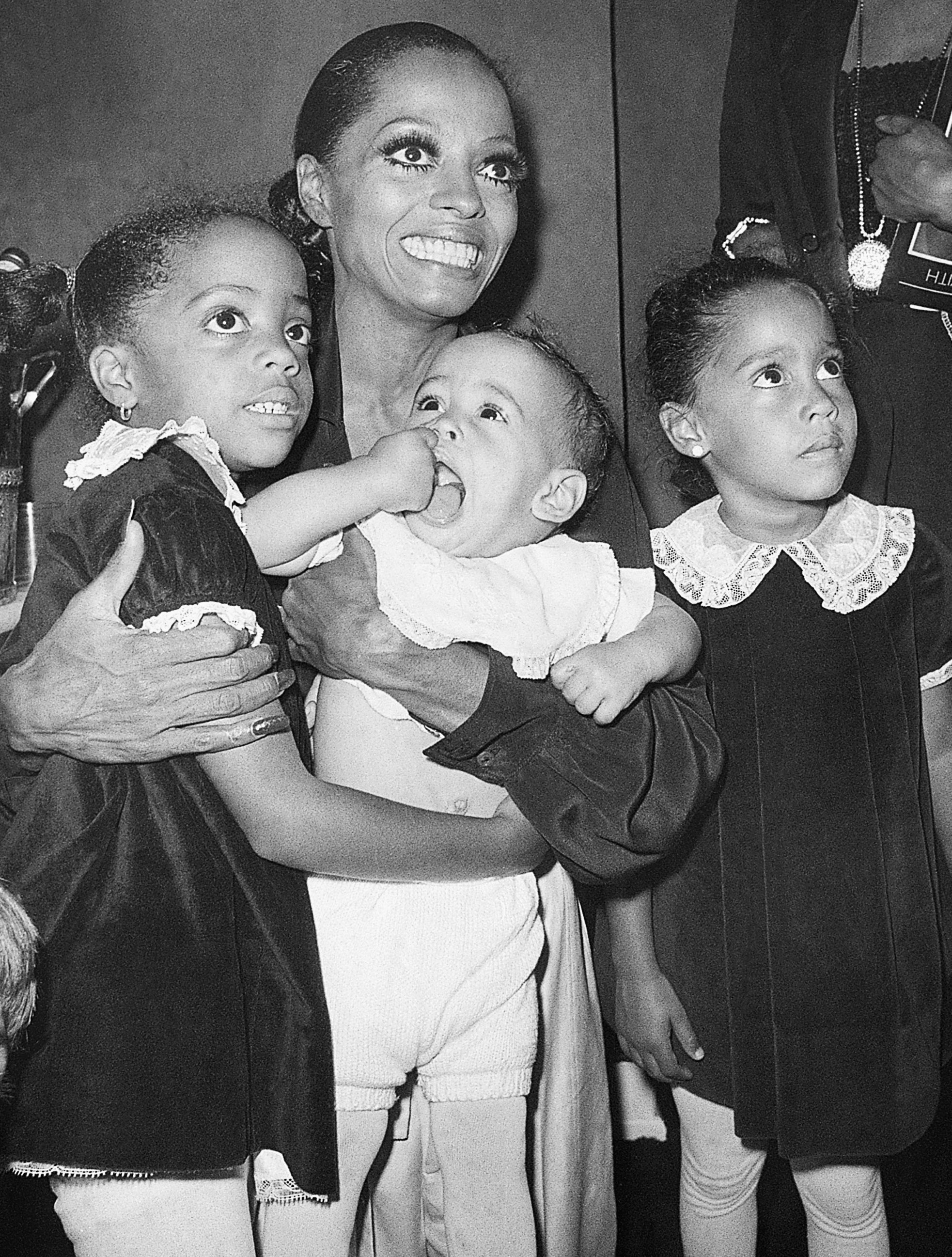 Diana Ross cuddles her children portion wearing glam makeup