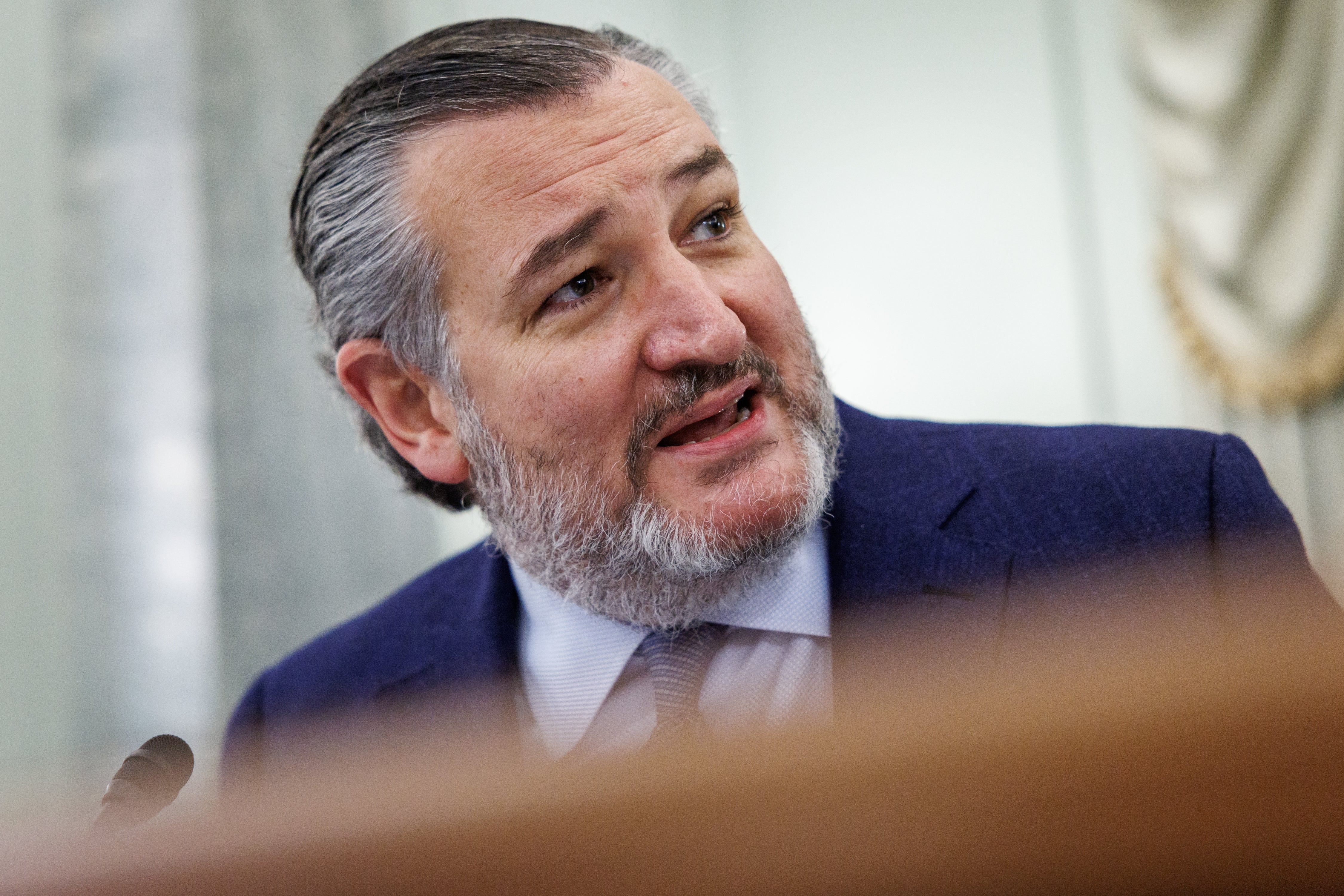 A idiosyncratic with a beard wearing a suit, captured speaking oregon successful conversation