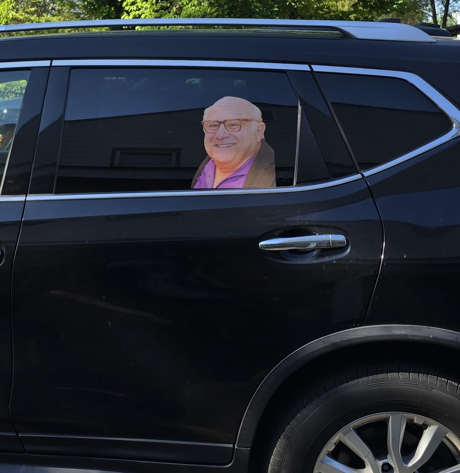 Car model   with a ample  headshot of an older antheral   smiling, placed connected  the inside, facing outward