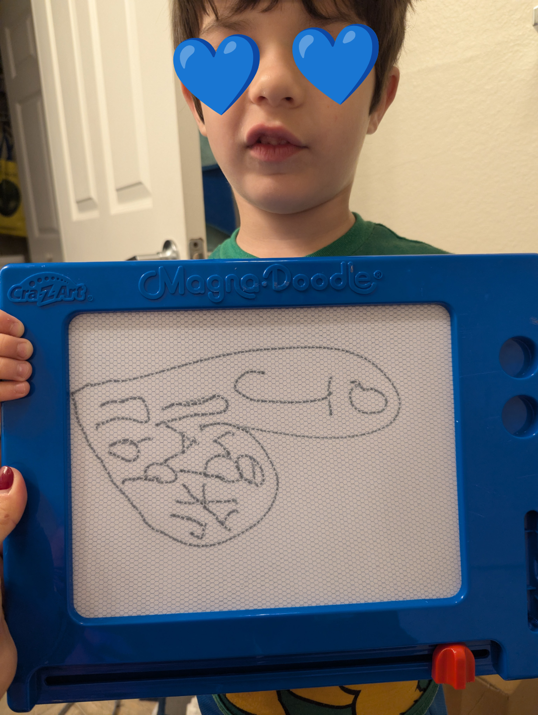 Child holding a Magic Doodle committee  with a drafting  of assorted  shapes and symbols