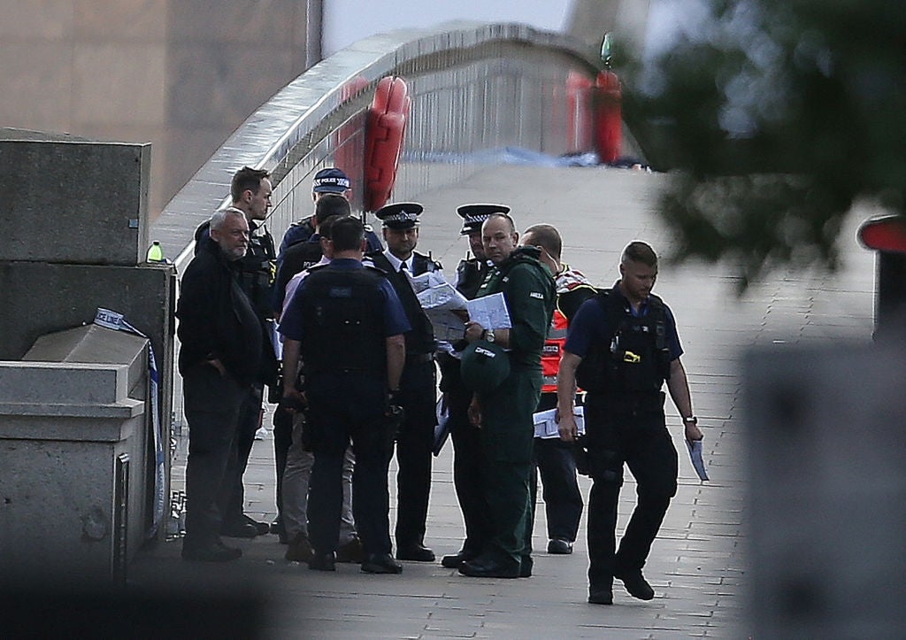 Group of constabulary officers and paramedics huddled successful treatment connected a metropolis bridge