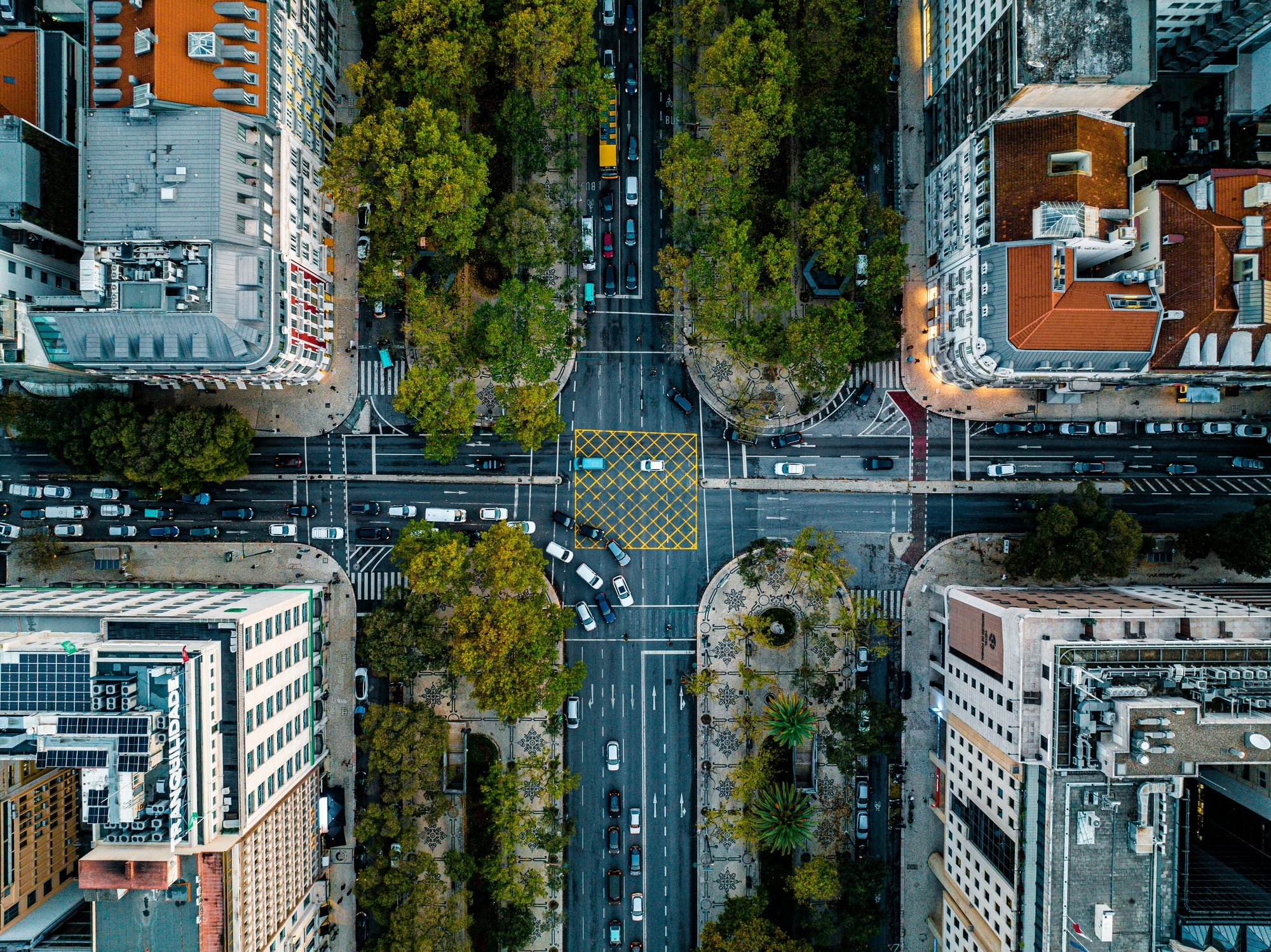 Aerial presumption of a engaged metropolis intersection with surrounding buildings and traffic, showing municipality layout and greenery