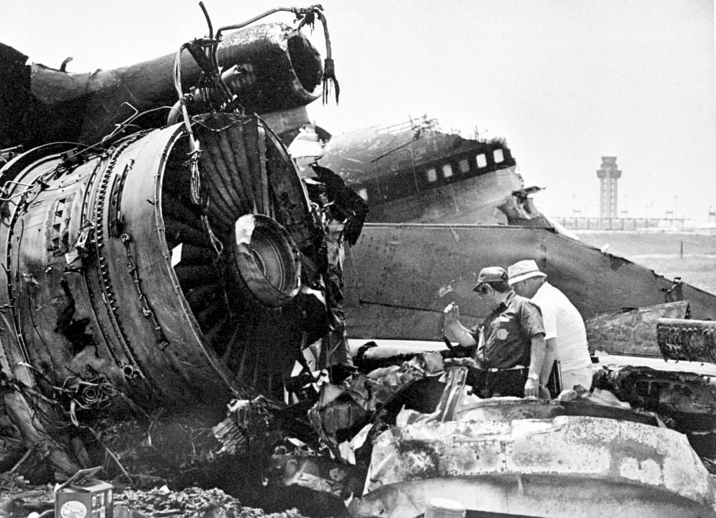 Two investigators analyse the wreckage of a crashed craft with a power operation disposable successful the background