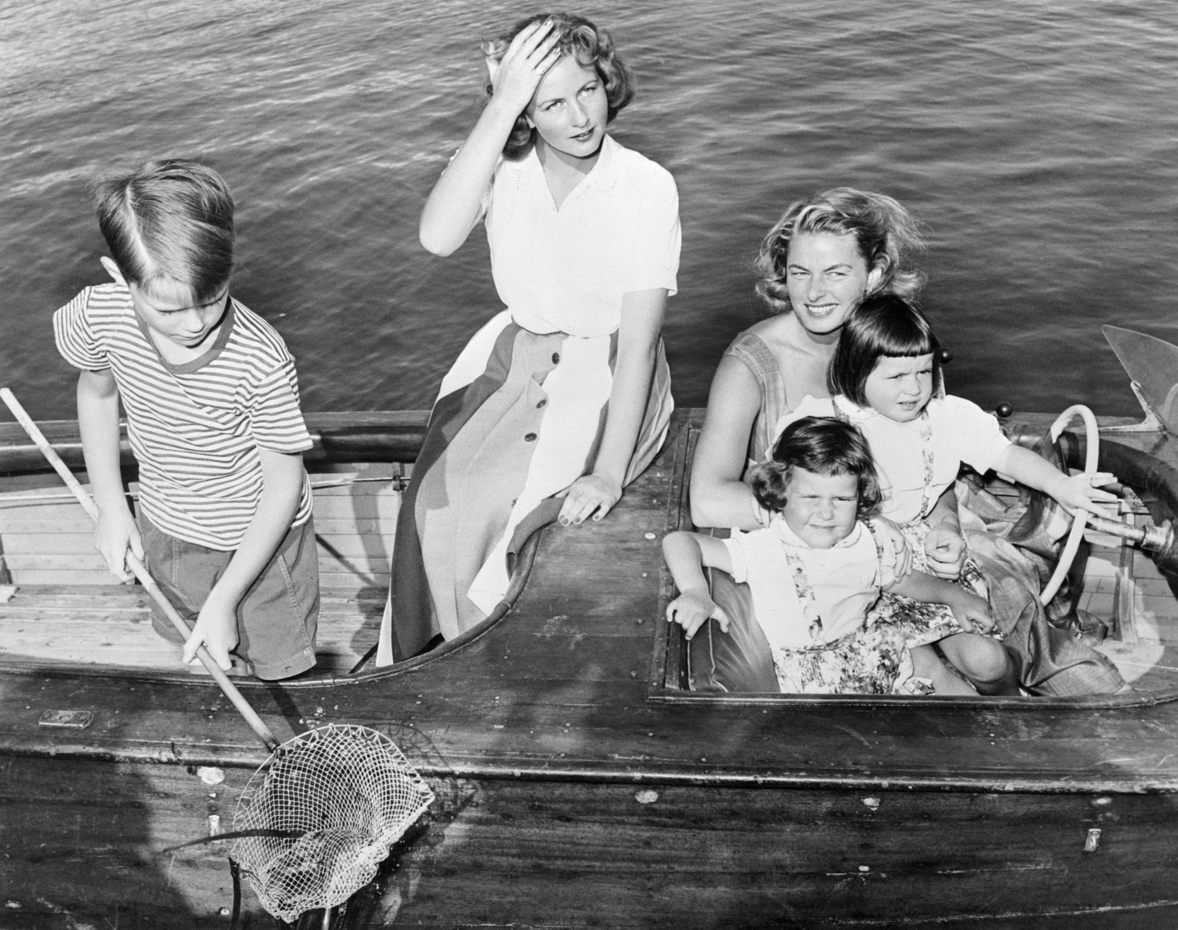 Ingrid Bergman sits connected a vessel with her children