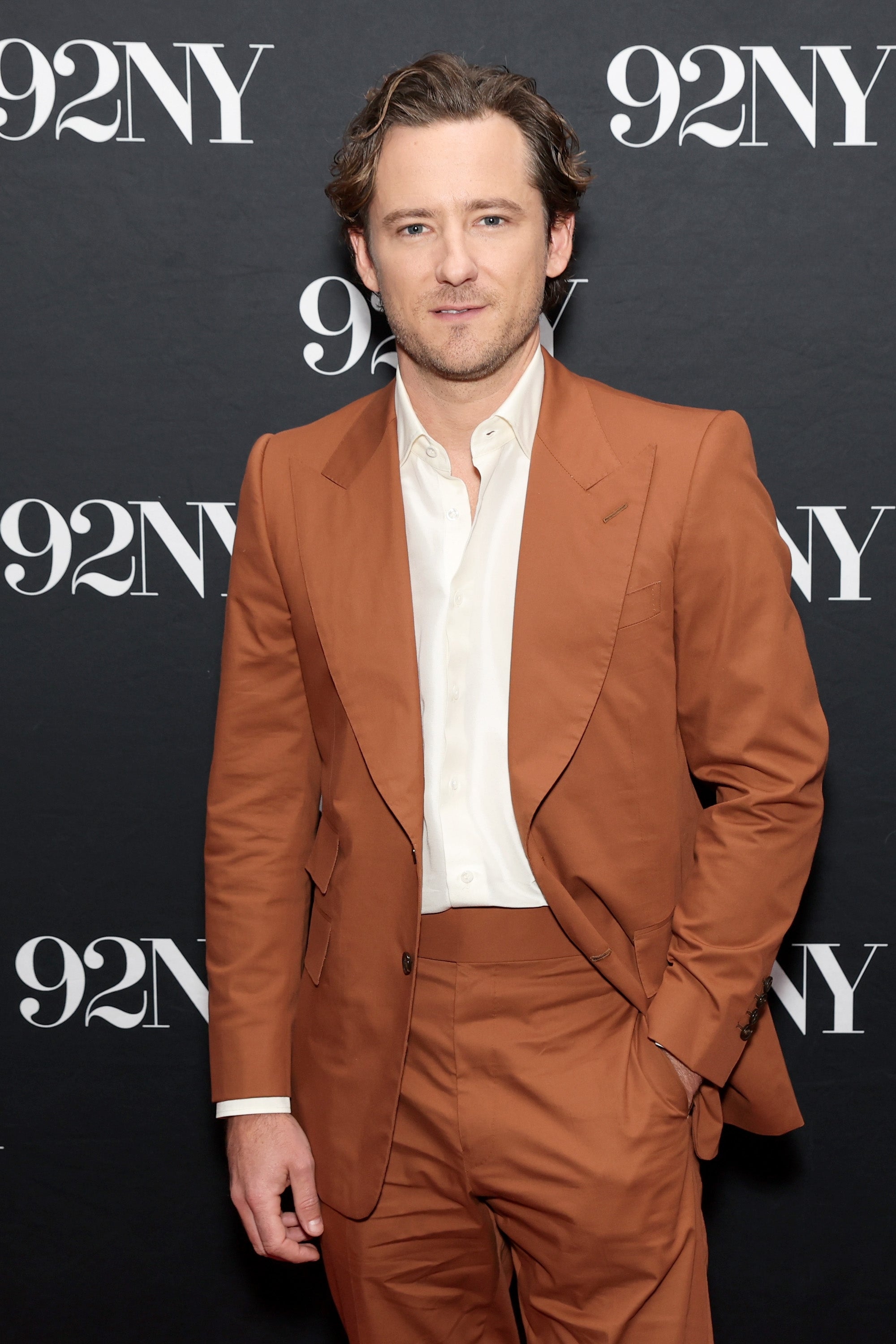 Lewis Pullman successful a sleek, tailored suit with a achromatic shirt, connected a reddish carpet