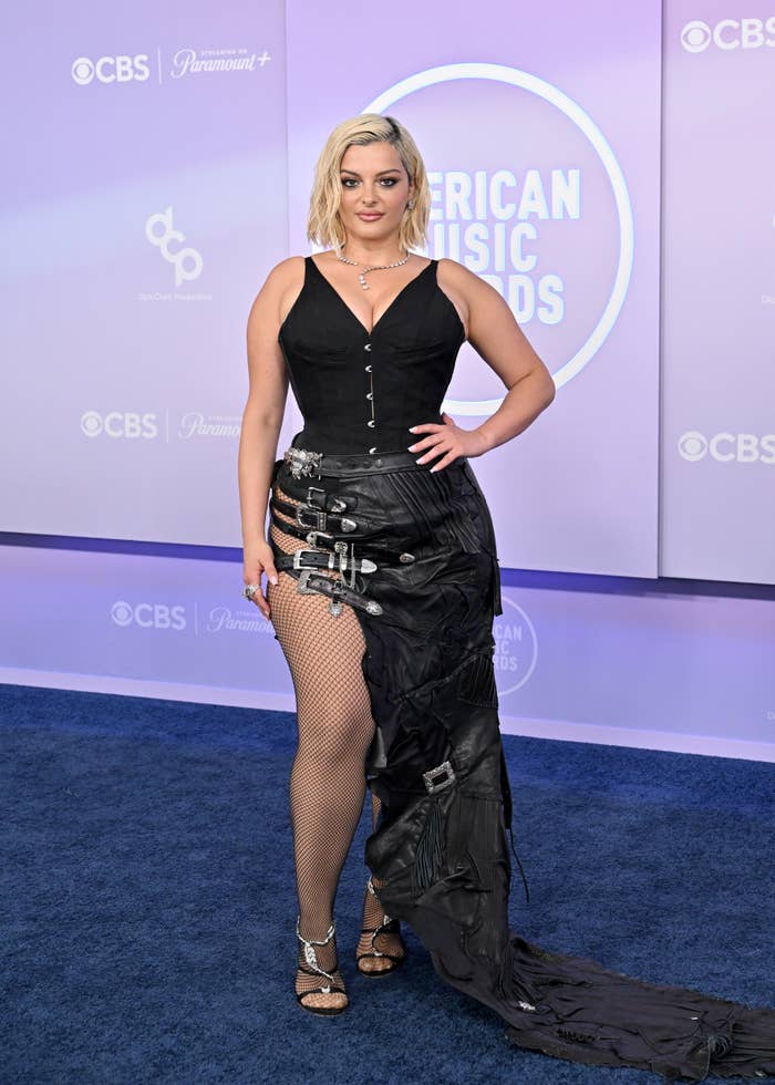 Bebe Rexha successful  edgy gown with buckles and fishnet stockings astatine  a media lawsuit   backdrop