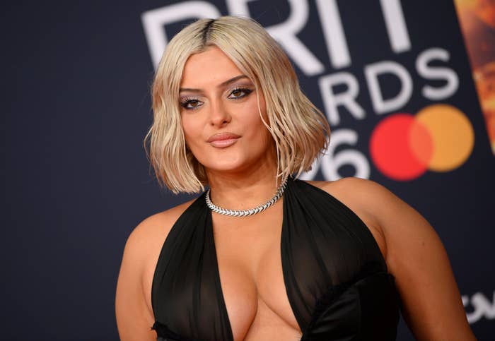 Bebe Rexha successful  an elegant gown with a plunging neckline connected  reddish  carpet astatine  the BRIT Awards