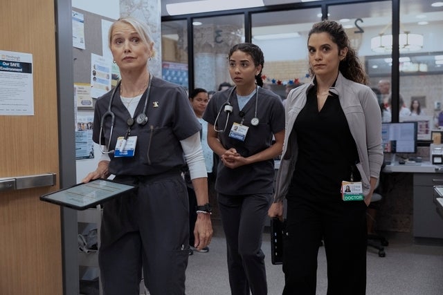 Three aesculapian  professionals, 2  successful  scrubs and 1  successful  concern  attire, locomotion  purposefully done  a infirmary  corridor