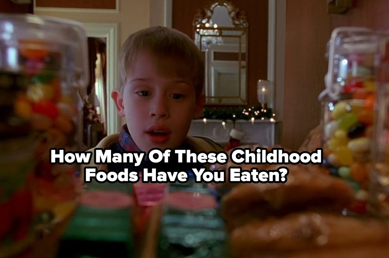 Child looking amazed at a table filled with various sweets and snacks, captioned "How Many Of These Childhood Foods Have You Eaten?"