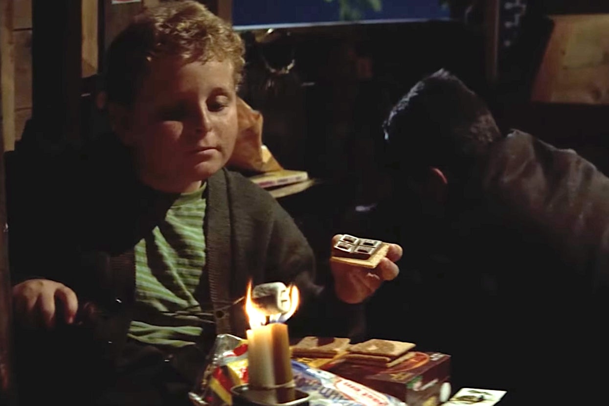 Patrick Renna as Ham in Sandlot toasts a marshmallow over a candle, creating a s'more