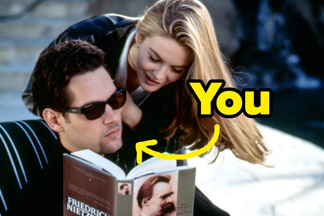 Paul Rudd as Josh reading a Nietzsche book while Alicia Silverstone as Cher looks over his shoulder, with the word "You" and an arrow pointing to Paul's face