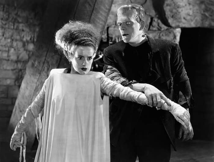 A classic scene with two iconic movie monsters, Frankenstein's creature and the Bride, poised dramatically in a gothic setting