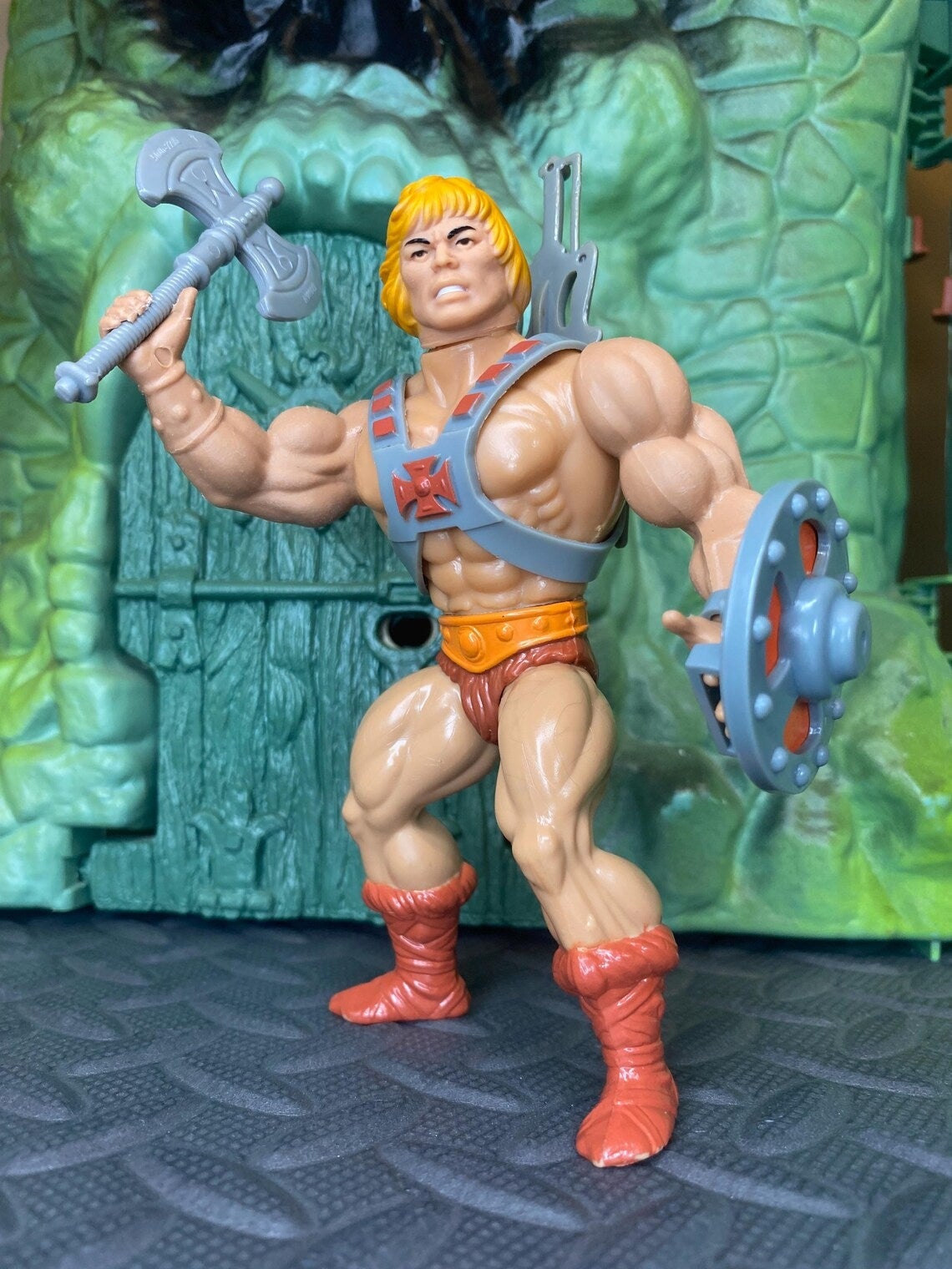 He-Man enactment   fig  with sword and shield posed successful  beforehand   of Castle Grayskull playset